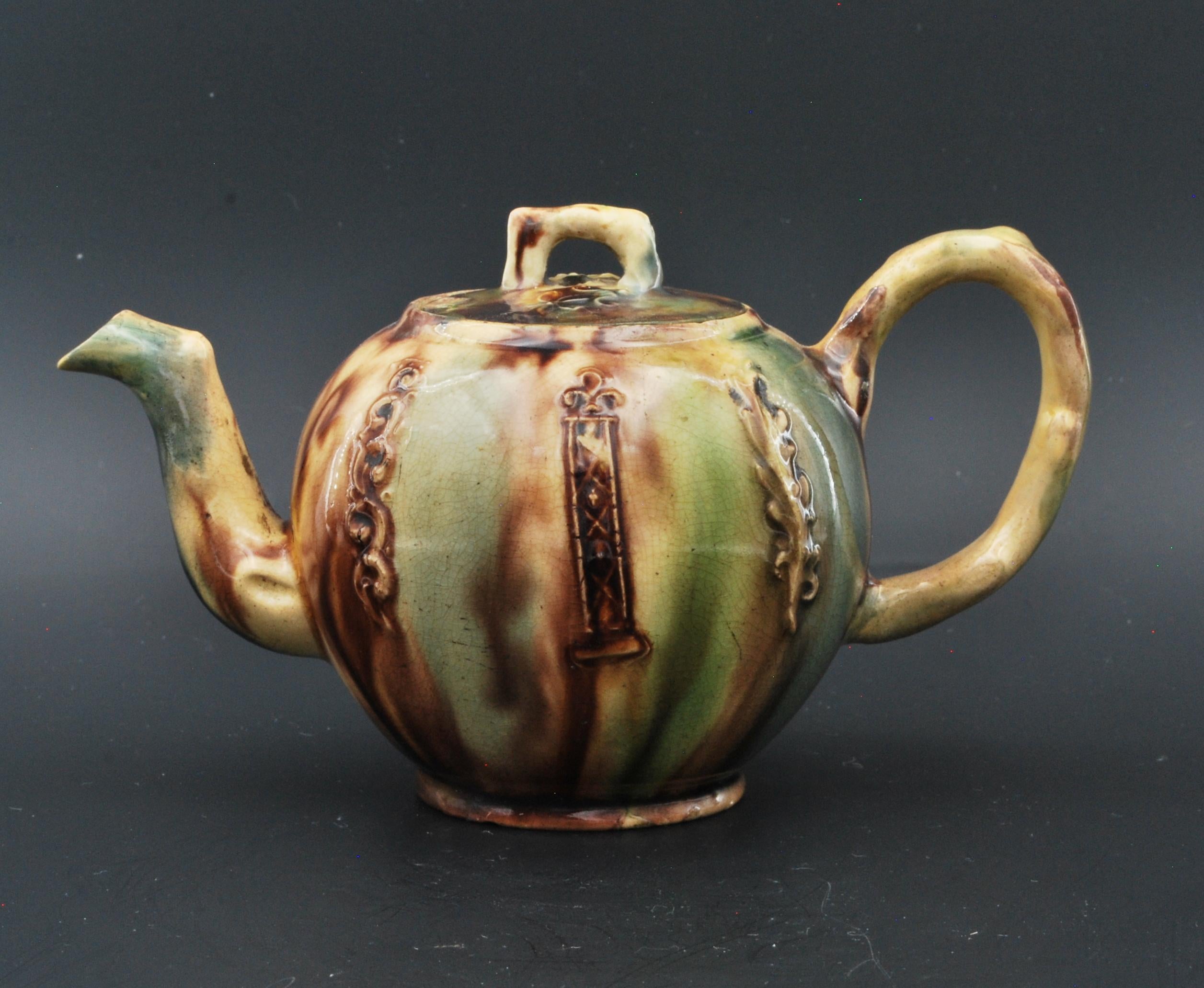 A charming, tiny, one-cup teapot in creamware with crabstock handle and spout, and ‘Whieldonware’ decoration. Teapots of this size date from the time each person was given his own pot, and tea bowls were very small.