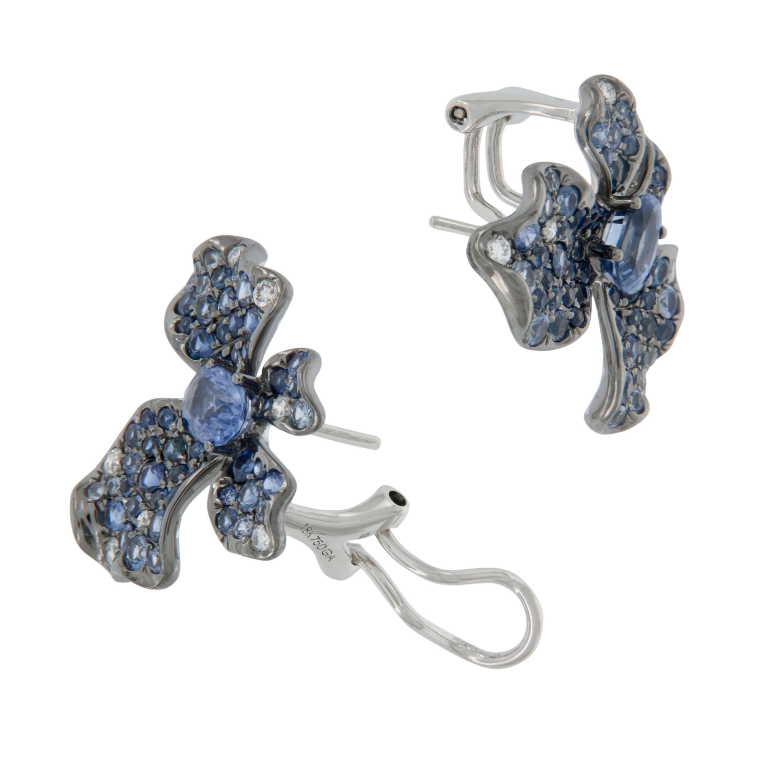 These fluid and ethereal earrings are simply elegant! With 3.61 Cttw various tones of fine blue sapphires accented by 0.22 Cttw white diamonds, you will be elated wearing them. With posts & clip backs for security of wear. Complimentary signature