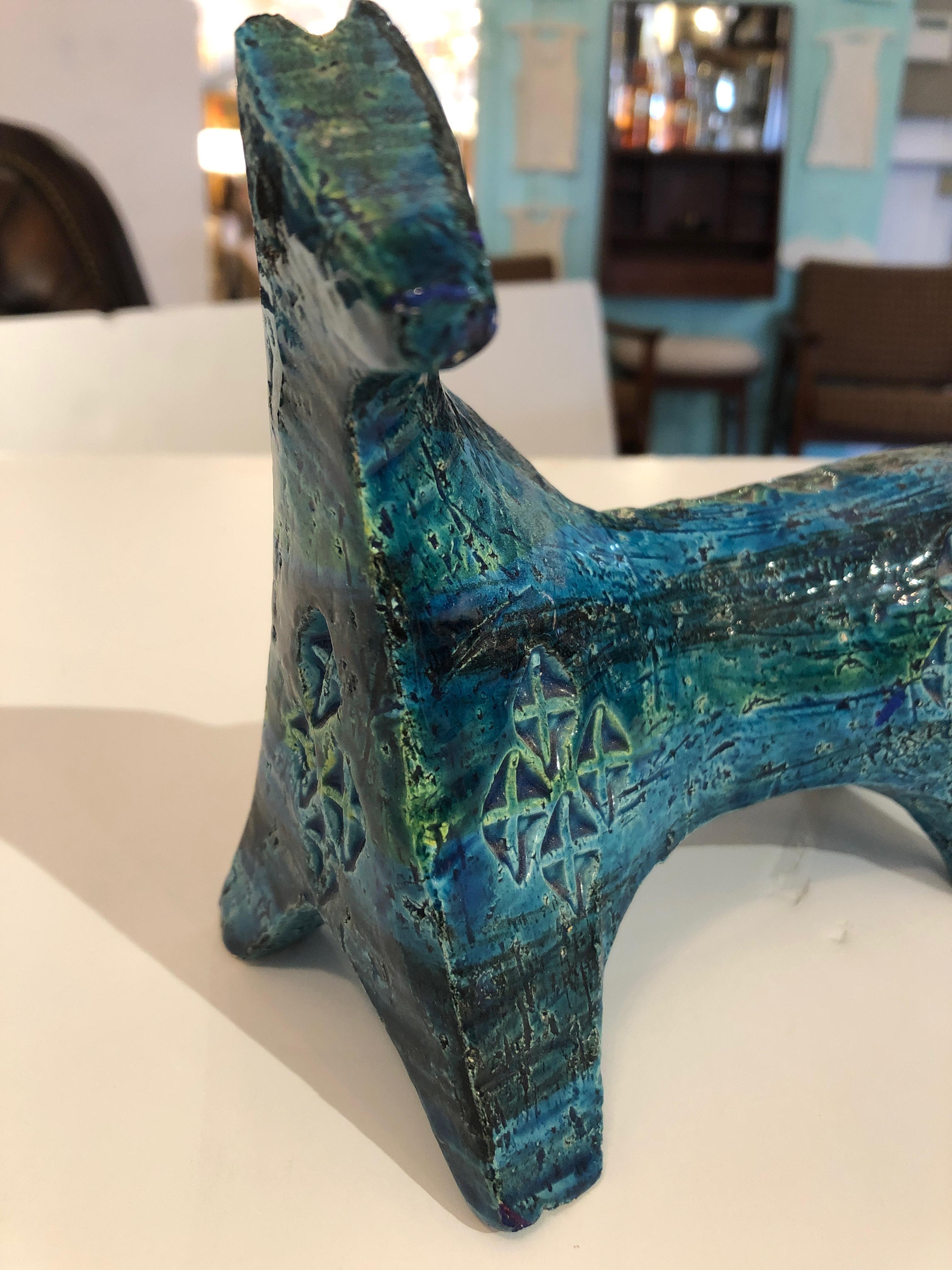 Abstracted form of a horse designed by Aldo Londi in the Blue Rimini style series for Bitossi, Italy.
Wonderful turquoise and green coloration and geometric decoration.