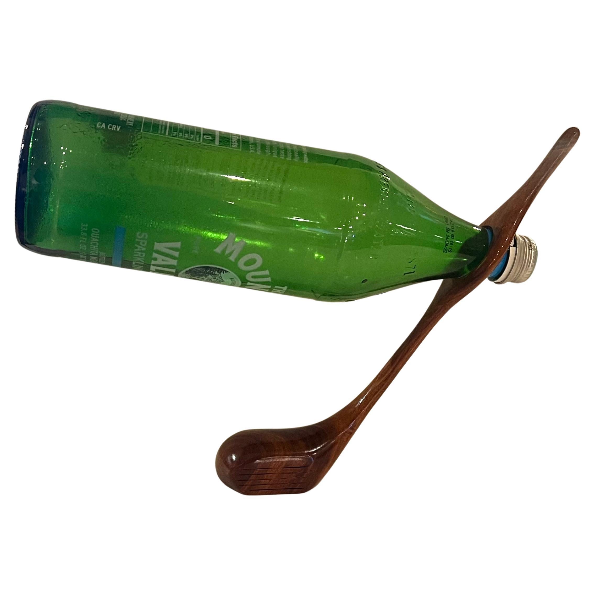 well balanced solid walnut golf club sculpture , wine holder circa 1980's great conversation piece perfect for any mans cave.