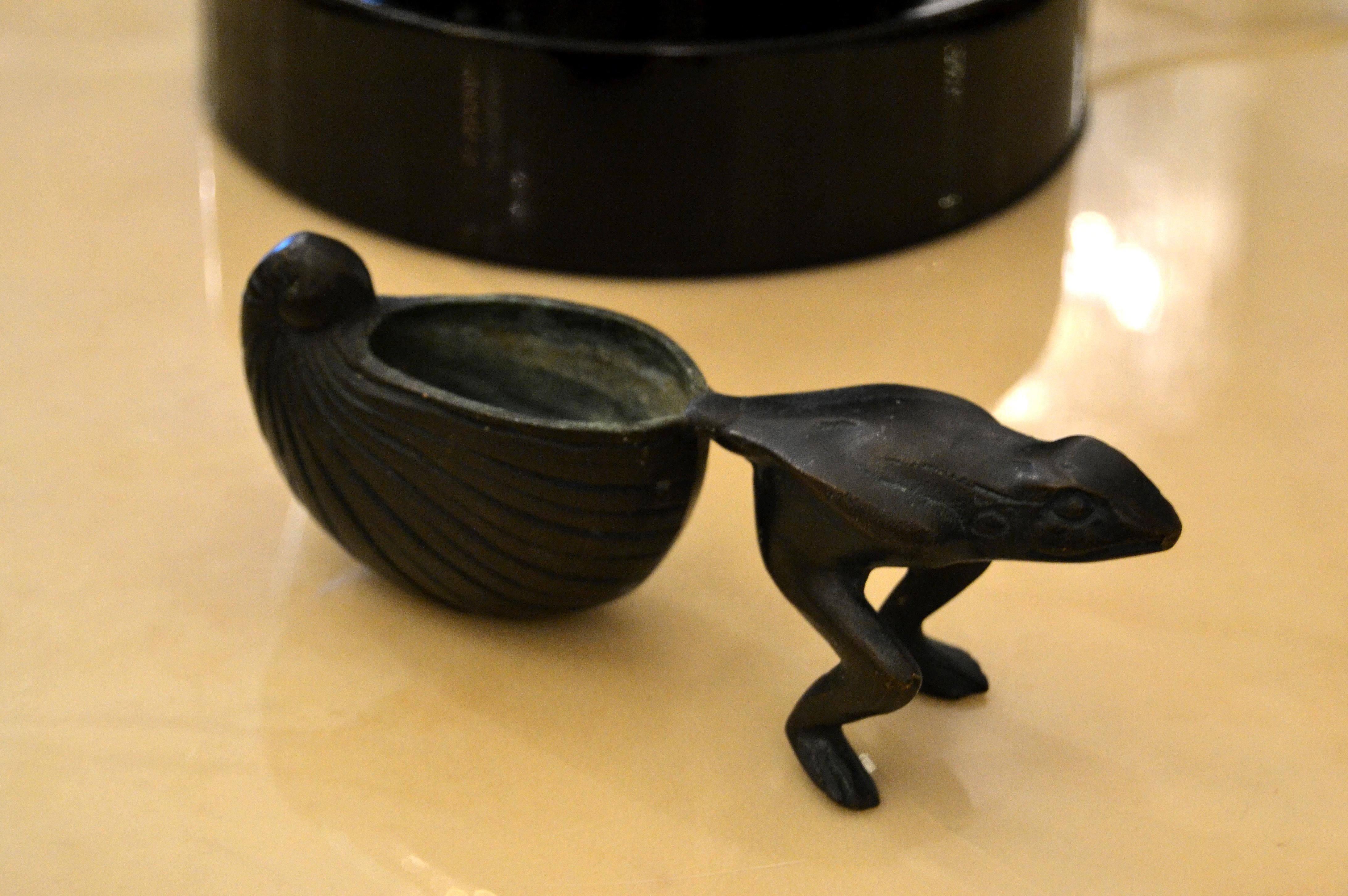 Mid-Century Modern Asian inspired bronze frog, animal sculpture pulling an upturned shell that serves as a bowl or a miniature flowerpot planter.
  