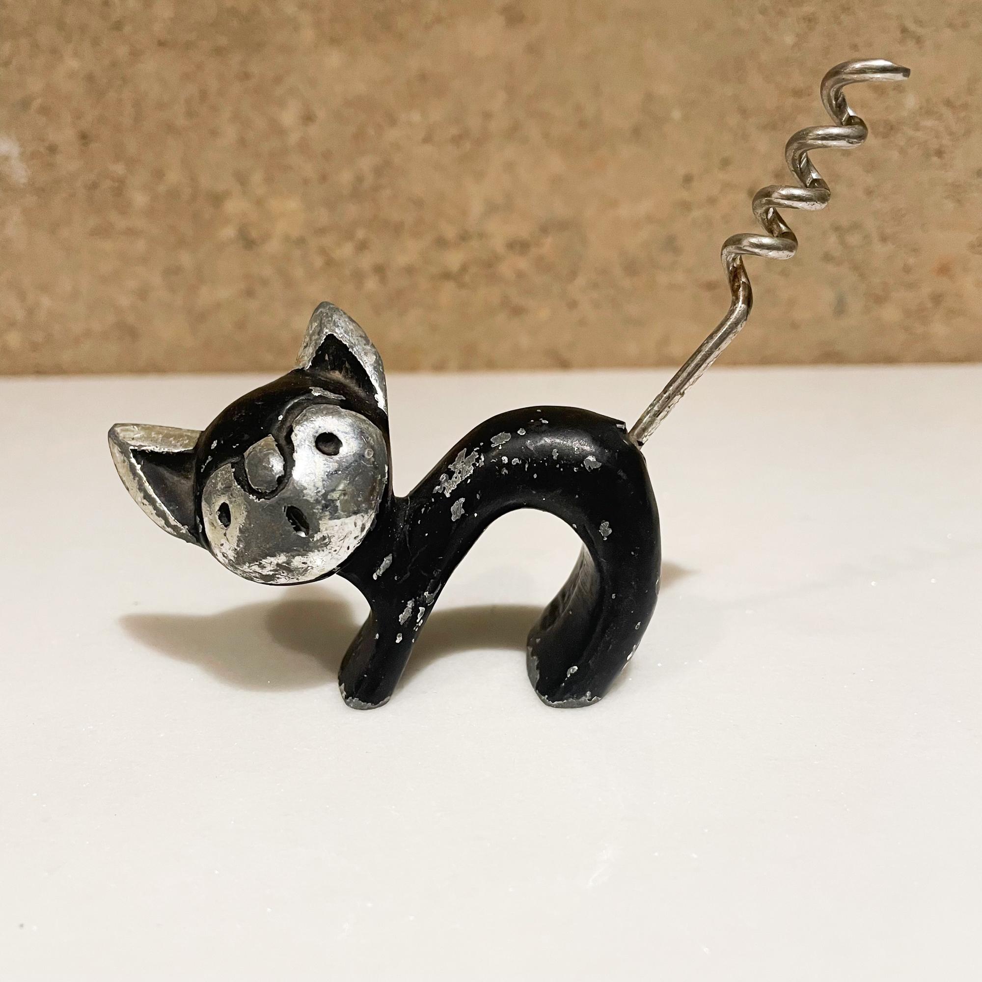 Bottle Opener
Delightful Mid-Century Modern cat wine bottle corkscrew opener 1950s
Black paint on aluminum in chrome-plate.
Attributed to Walter Bosse for Hertha Baller.
Unmarked.
Measures: 4.25 W x 1.25 D x 3.25 tall inches
Original vintage