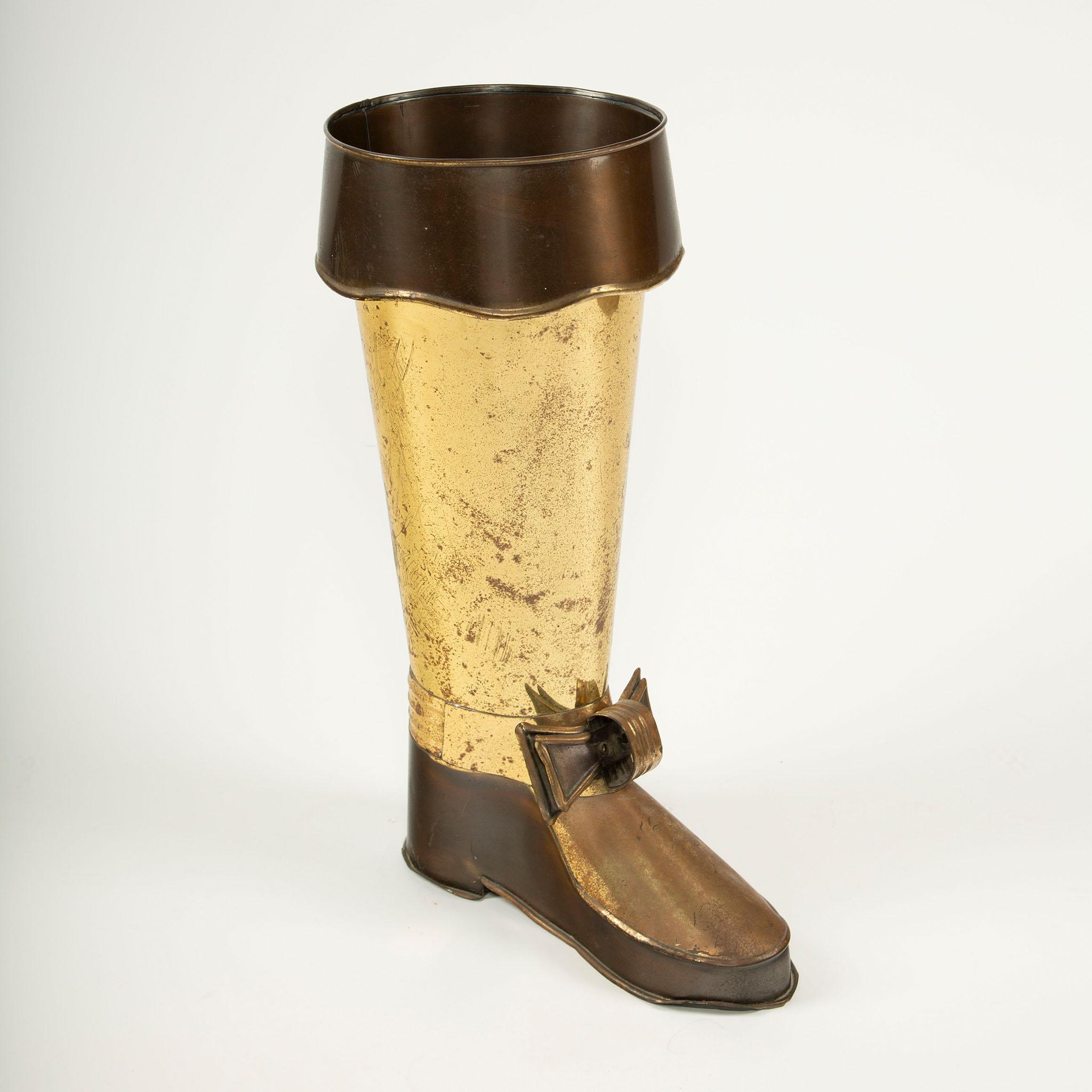 Porte-parapluies vintage en laiton en forme de botte

Porte-parapluie fantaisiste en laiton du milieu du 20e siècle, modelé sous la forme d'une botte haute, avec une tige dorée, une manchette et un pied patinés plus foncés, ornés d'un nœud stylisé