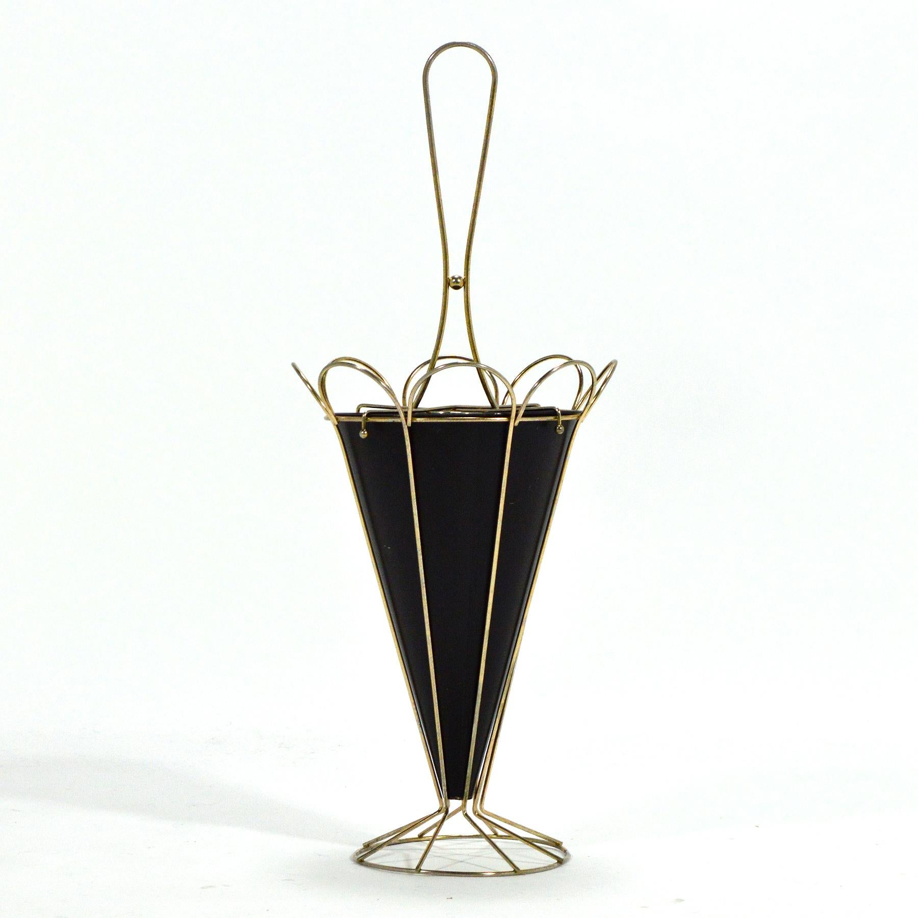 This delightful umbrella stand in brass rod and painted steel is in the form of an abstract umbrella. It is pretty when it is empty, and of course a very useful place to store your umbrellas. We love the playful nature of the design and the light