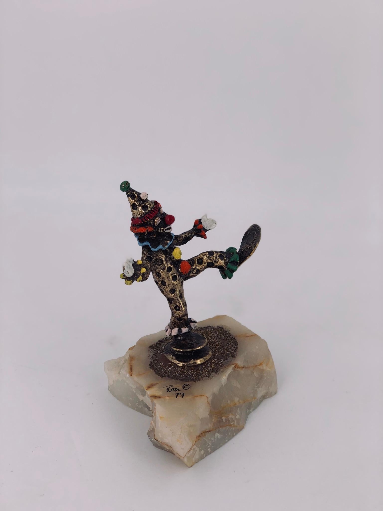 A small sculpture by artist Ron Lee, circa 1970s in bronze with enamel highlights sitting in raw marble base.