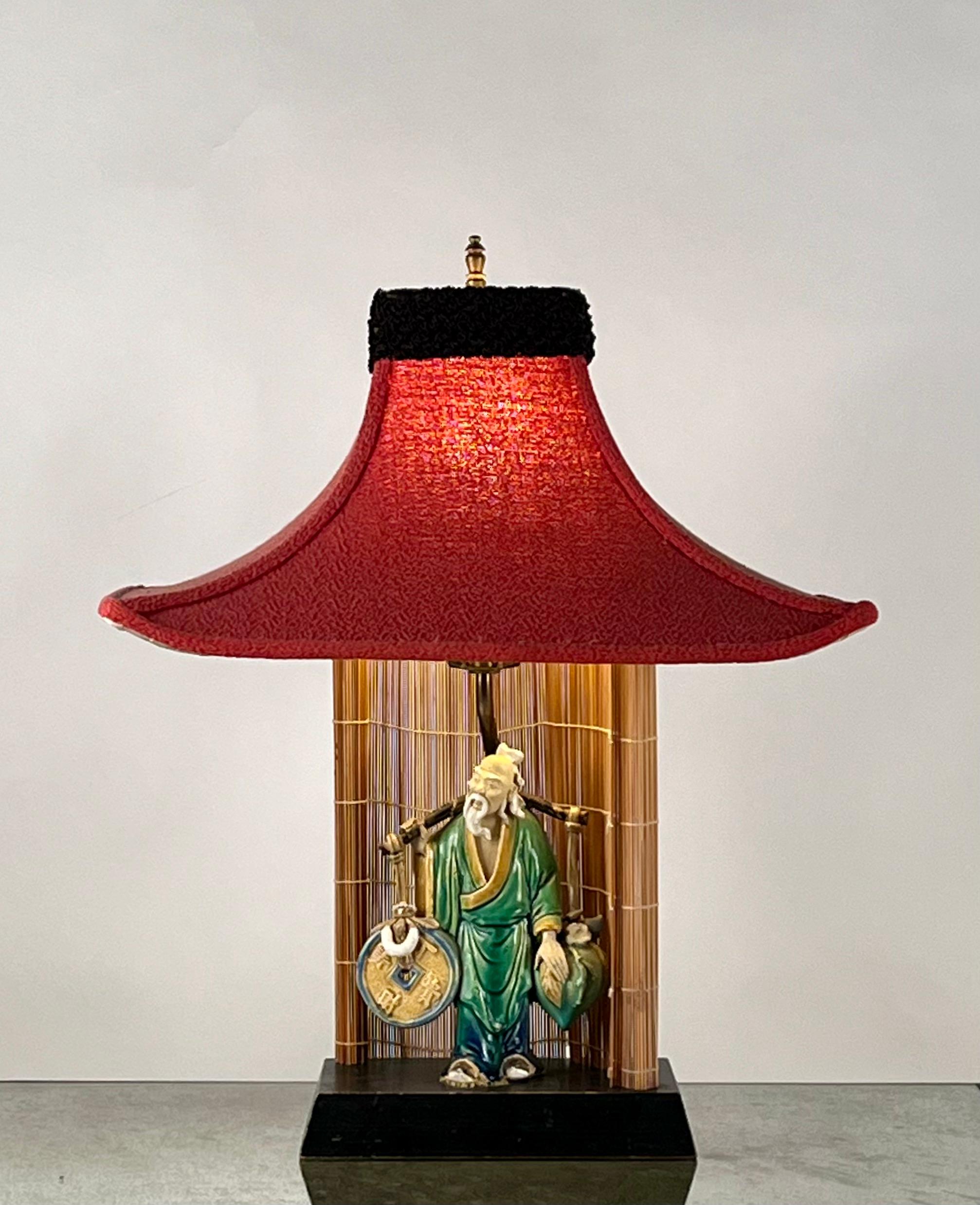 Whimsical Chinese figurine Midcentury ceramic lamp with original pagoda-shaped lampshade.