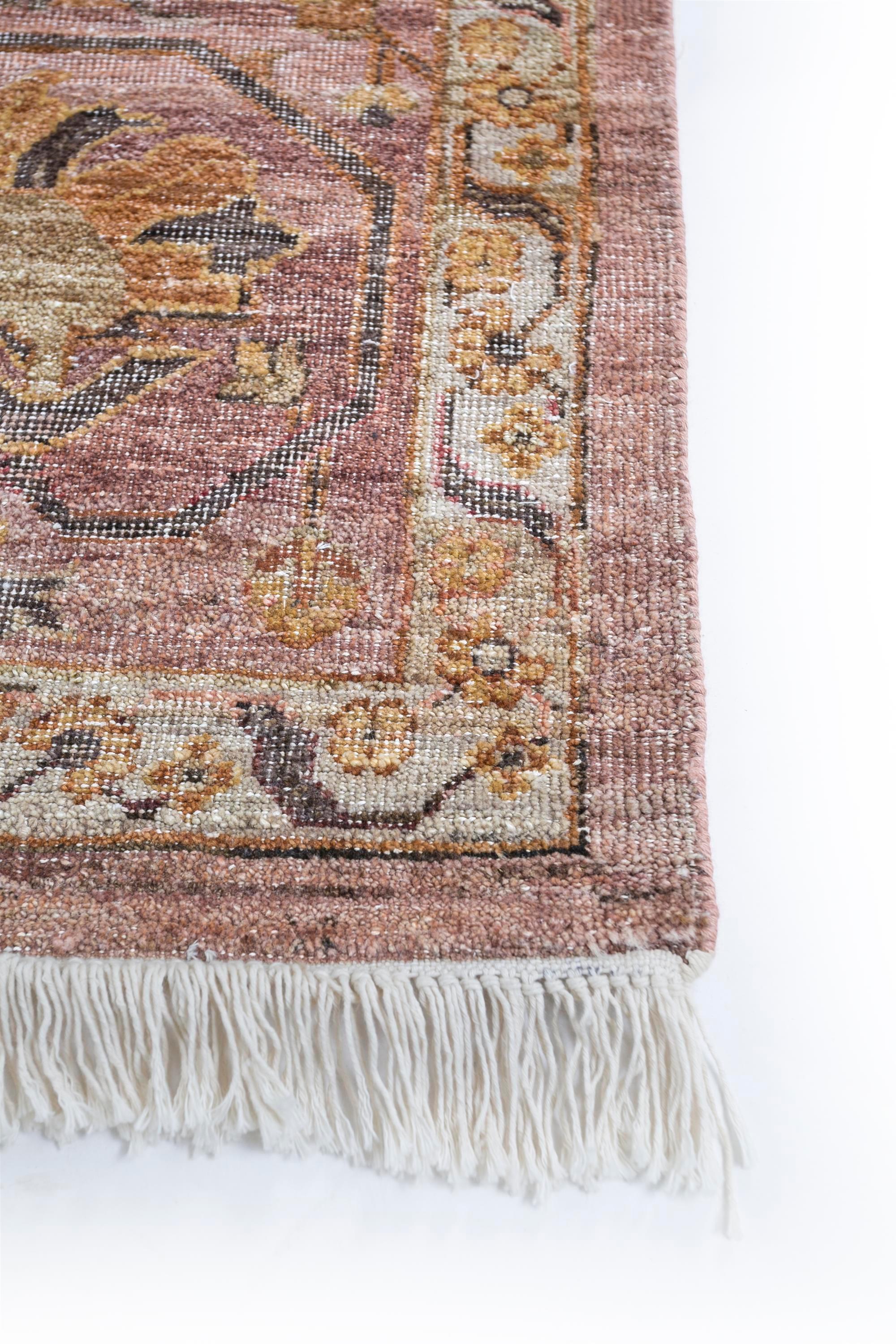 Step into the enchanting realm of this hand-knotted rug that is more than a mere floor covering—it's a captivating narrative. The soft coral ground and shell pink border paint a canvas that is a magnificent display of an alternate evolution,