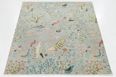 Caprichosa alfombra de lana india moderna Garden Paradise - Motivo de pájaro azul y coral suave