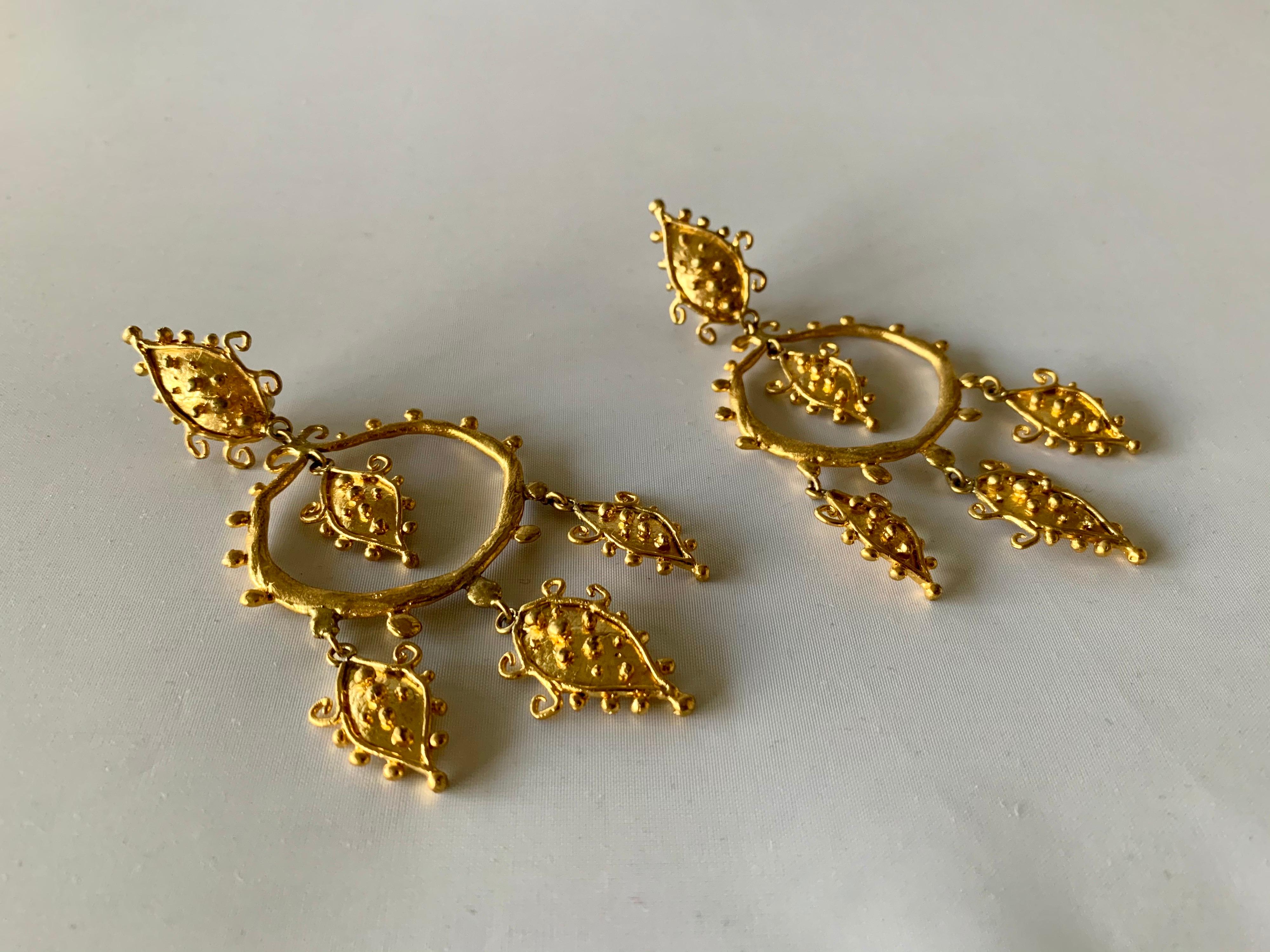 Stunning vintage fashion-forward Parisian statement earrings!  The whimsical clip-on statement earrings are comprised out of lightweight hammered gold-plated brass segments in a unique motif with dangling leaf-like accents. 

Herve Van Der