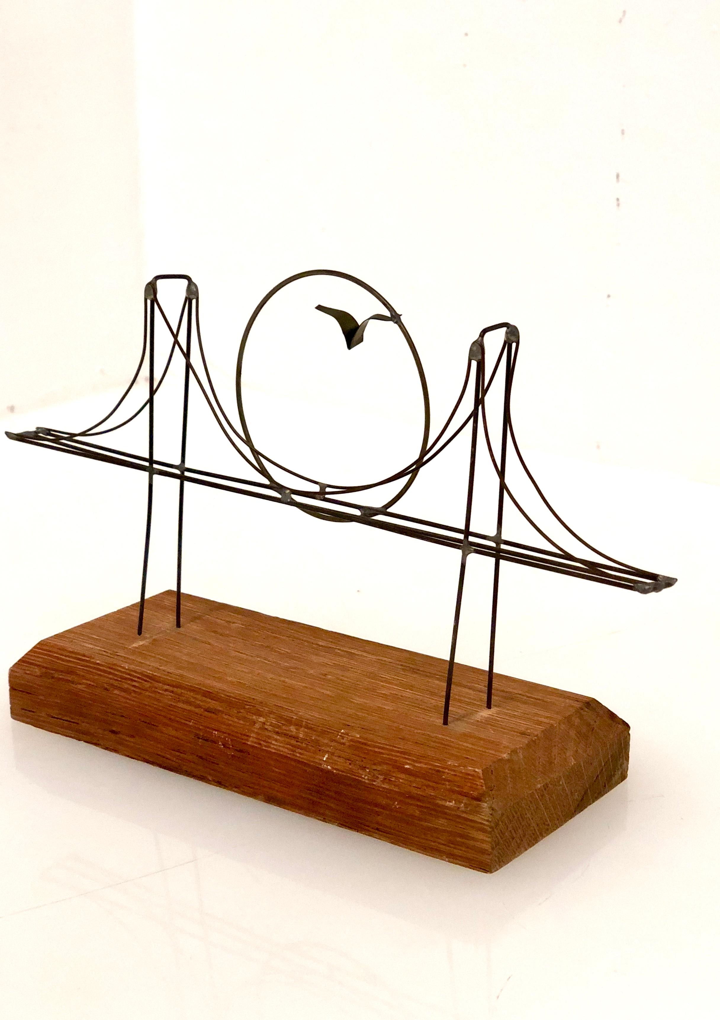 Cool petite wire desk sculpture of the golden gate bridge, San Francisco Bay Area circa 1970's, thin welded wire sitting on a solid mahogany base.