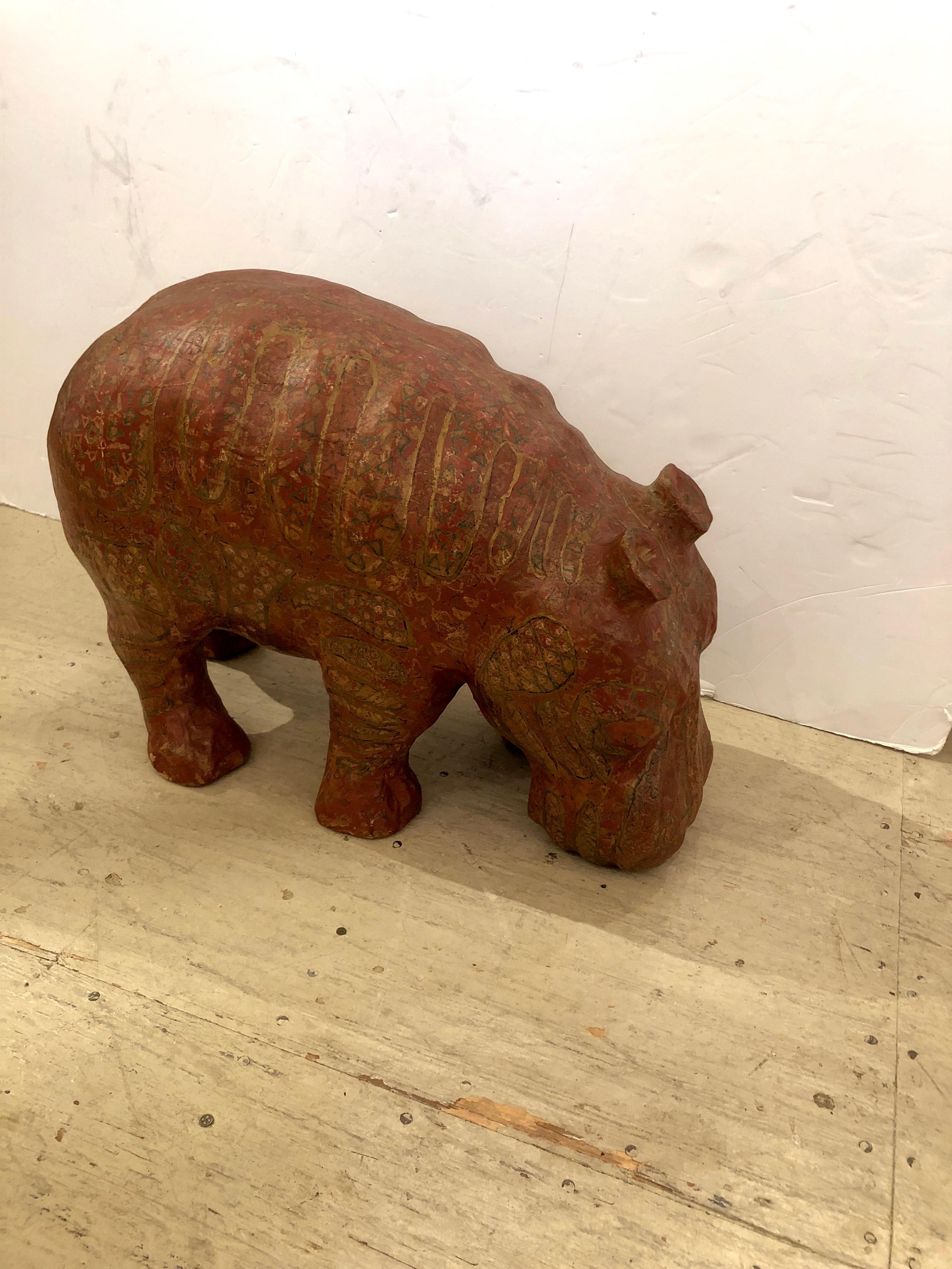 Wonderful large papier mâché sculpture of a hippo, hand painted with an elaborate pattern in a brick red color palette.