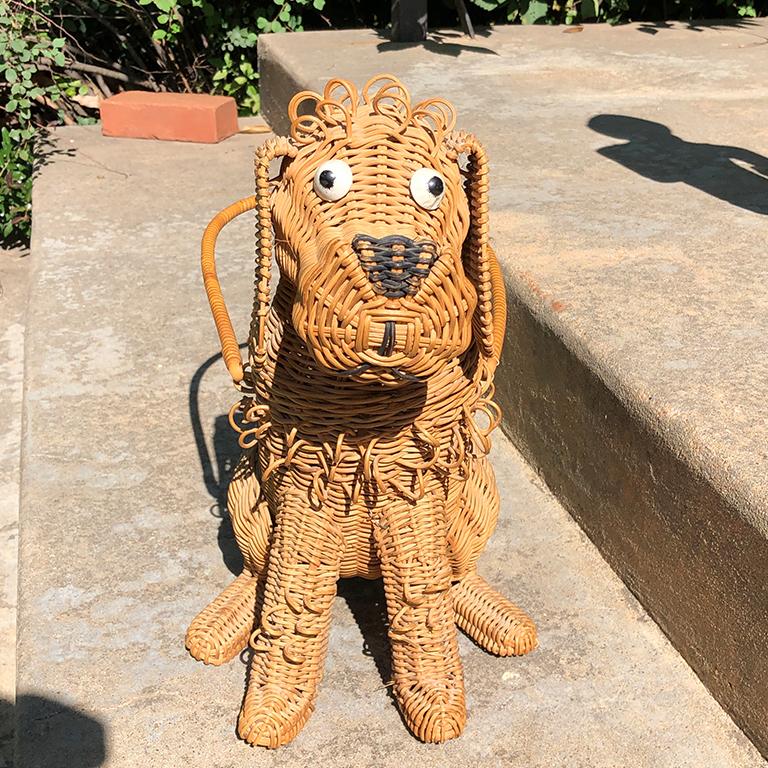 Whimsical extremely rare handmade artisan canine or dog basket, circa 1950s. Rare dog basket is fashioned by hand out of wicker. He has a removable head which attaches with a button. A tall basket handle (18