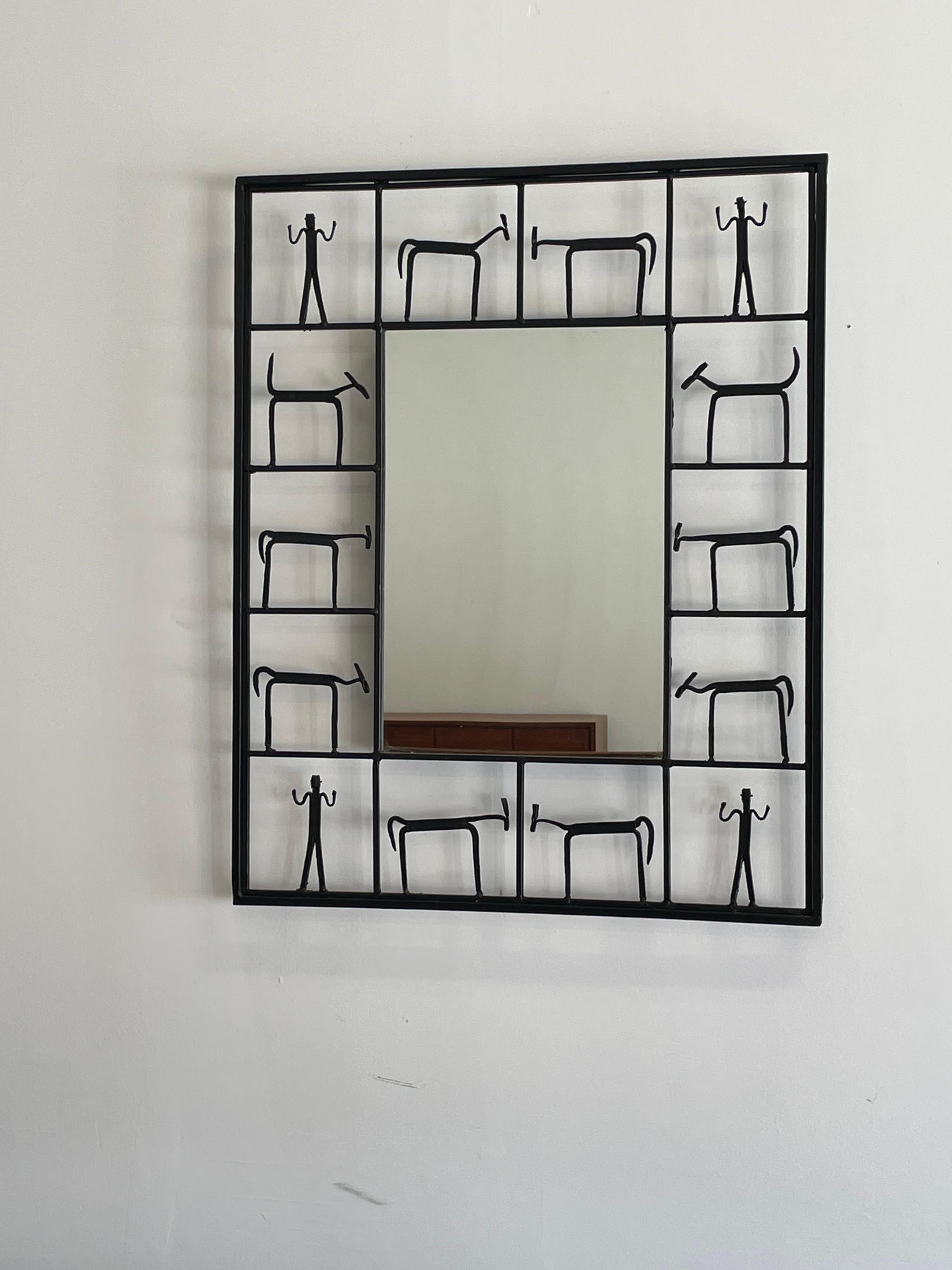 Whimsical mirror featuring an iron border that depicts figures and animals. Well built and ready for immediate use. 

Actual mirror portion measures 12” x 17.5”.