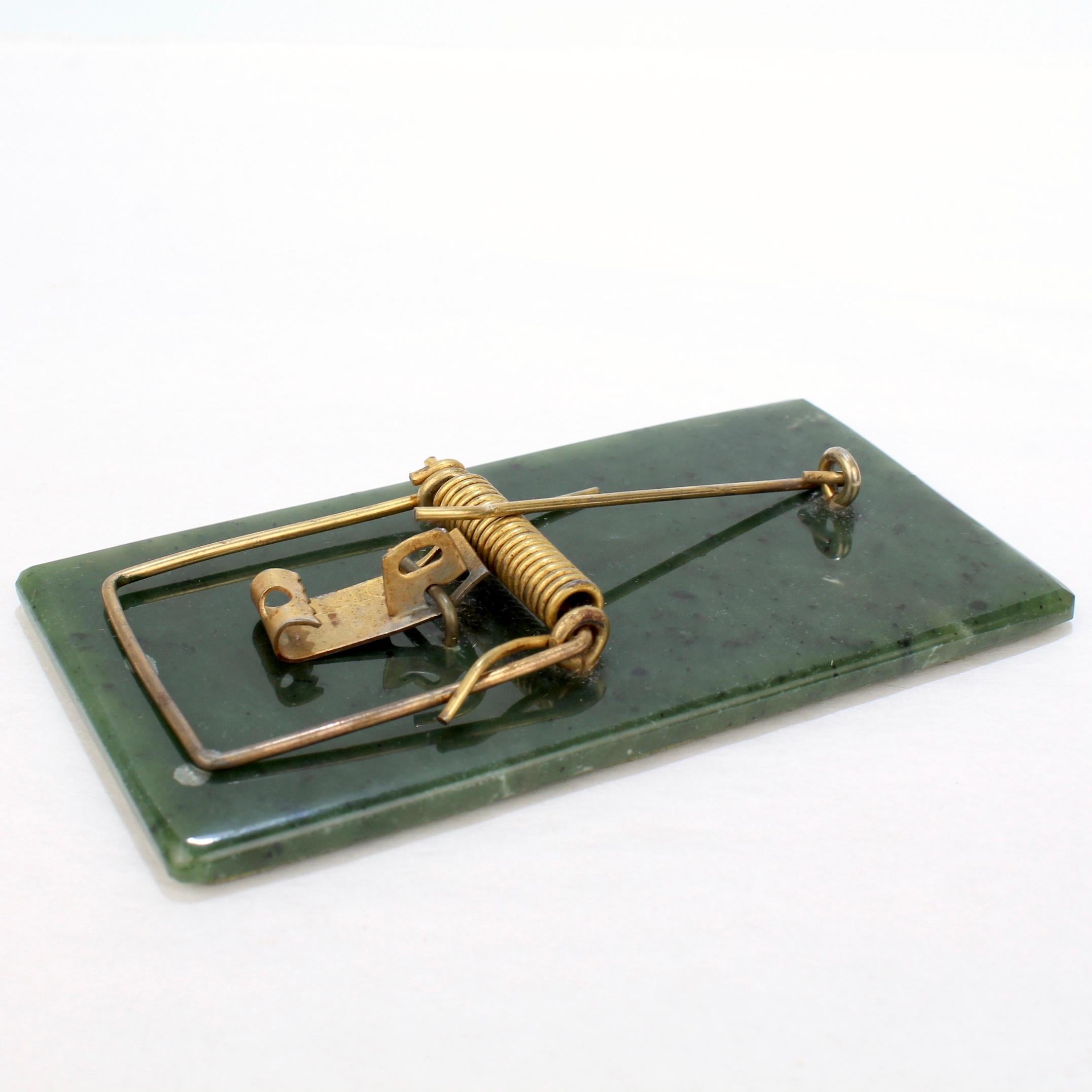 Clearly someone built a better mouse trap....

This amazing mouse trap is made of a polished platform of jadeite (probably Alaskan jade) with a gold plated wire spring, catch and hammer.

Someone seems to have tested the mechanism, and it looks to