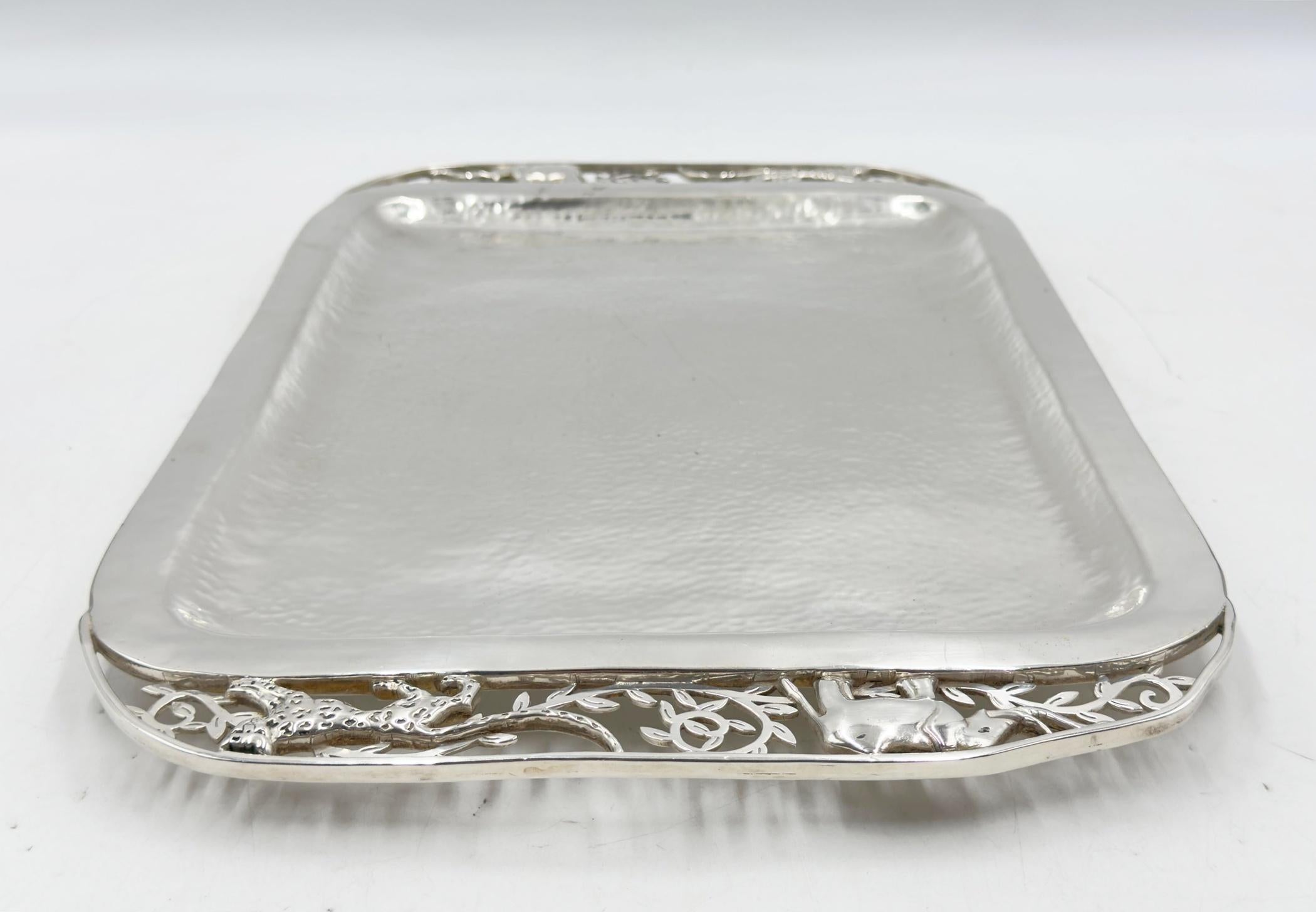 A striking silver plated serving tray by acclaimed Mexican designer Emilia Castillo, known for her whimsical and nature-inspired creations. This substantial piece features a hand-hammered surface and intricate pierced gallery edges with a sculptural