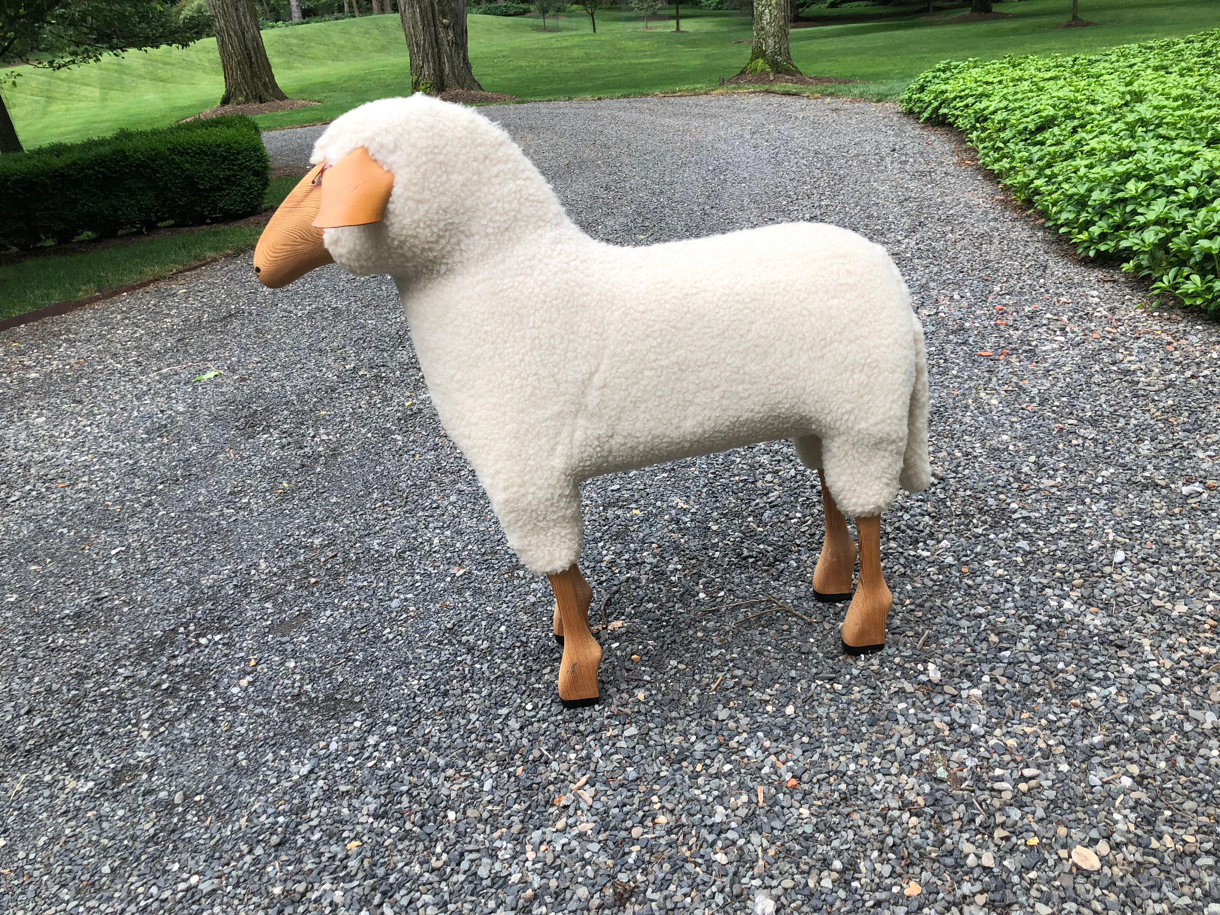 Beautiful life-size vintage sheep sculpture of beechwood and sheepskin. Handmade in Germany, the sheep has a lovely face and black painted feet and the ears are leather.