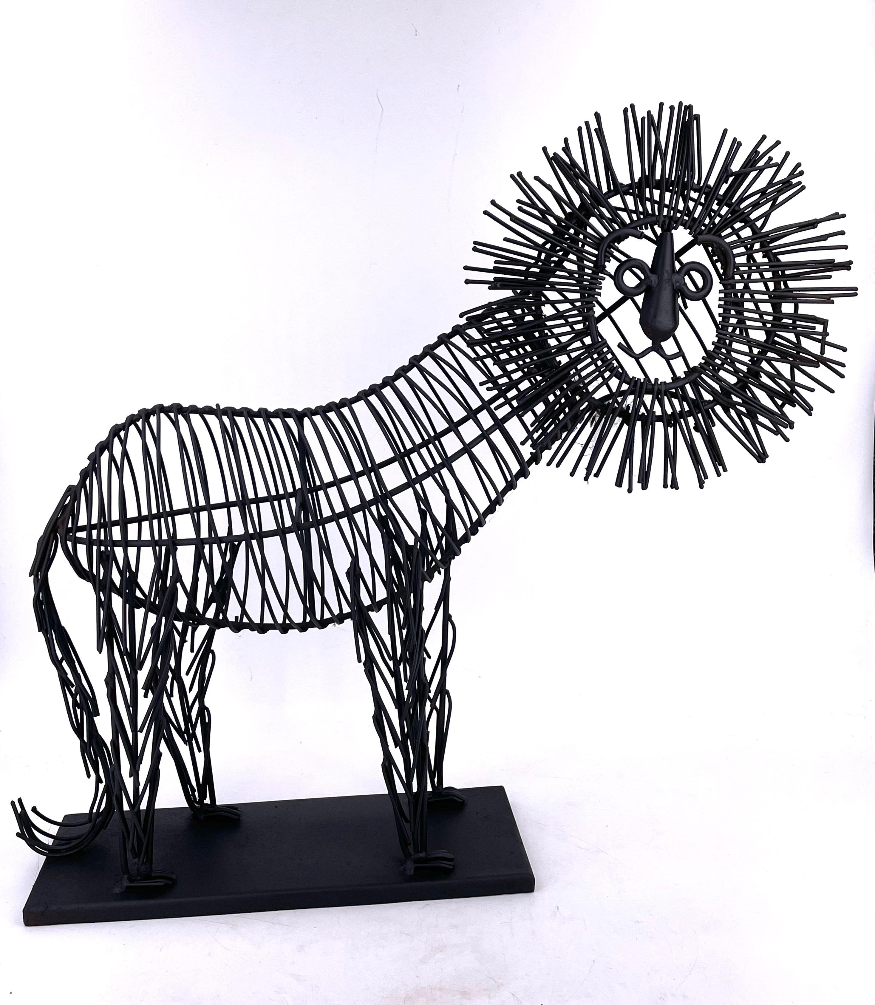 Fun, metal wire sculpture of a male lion sitting on a black metal base. The body is a black painted metal wire. The piece is unsigned but in the style of C. Jere, circa 1980s. Sergio.