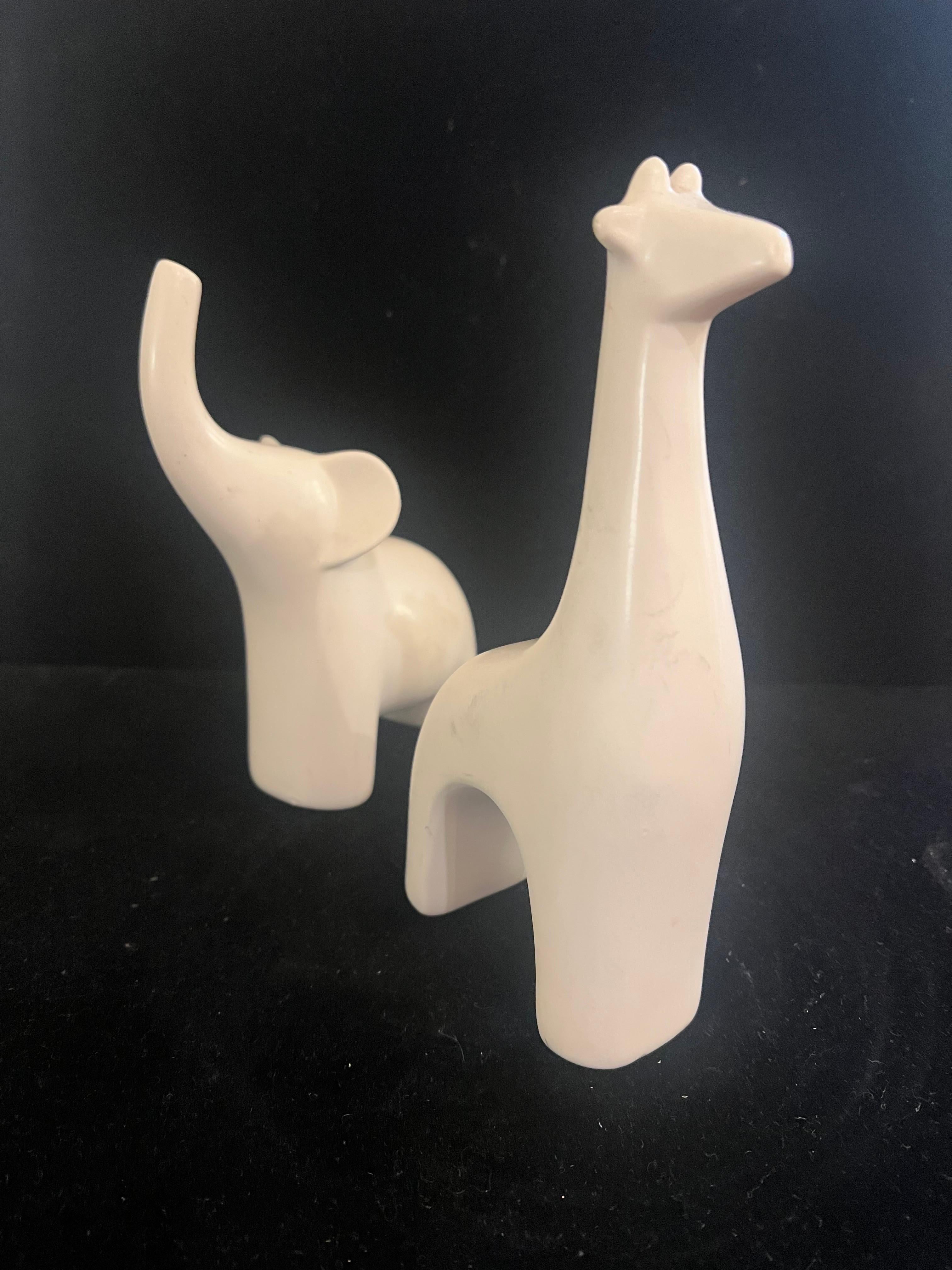 Whimsical Modernist Pair Of Elephant & Giraffe in Mate satin Porcelain Finish , nice condition circa 1980's no chips or cracks.