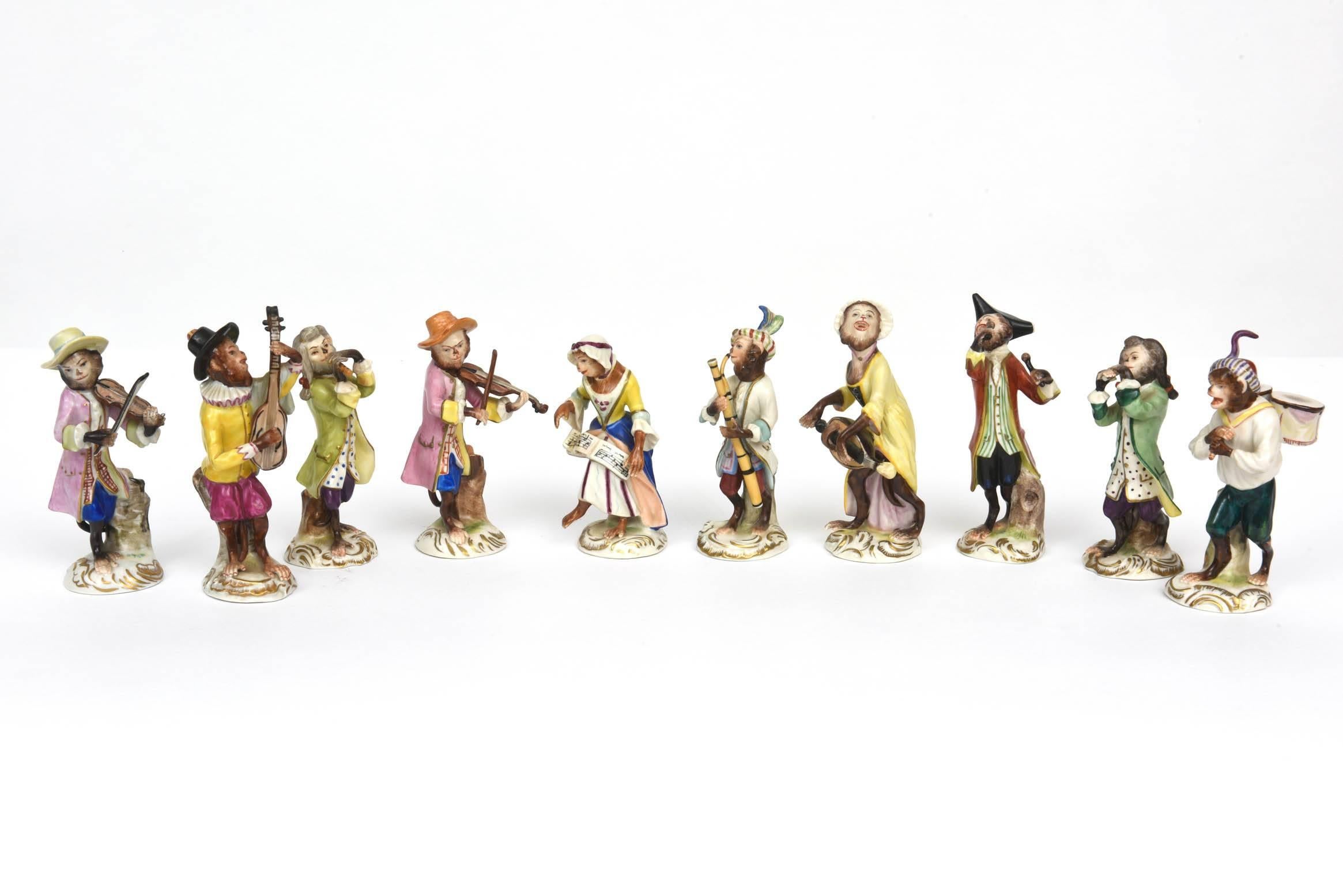 A charming set of whimsy featuring exquisitely molded fine Dresden Porcelain figurines from the designs inspired by the famous monkey orchestra produced for Meissen in the 18th century by Johann Joachim Kändler (German, 1706-1775). Kändler was one