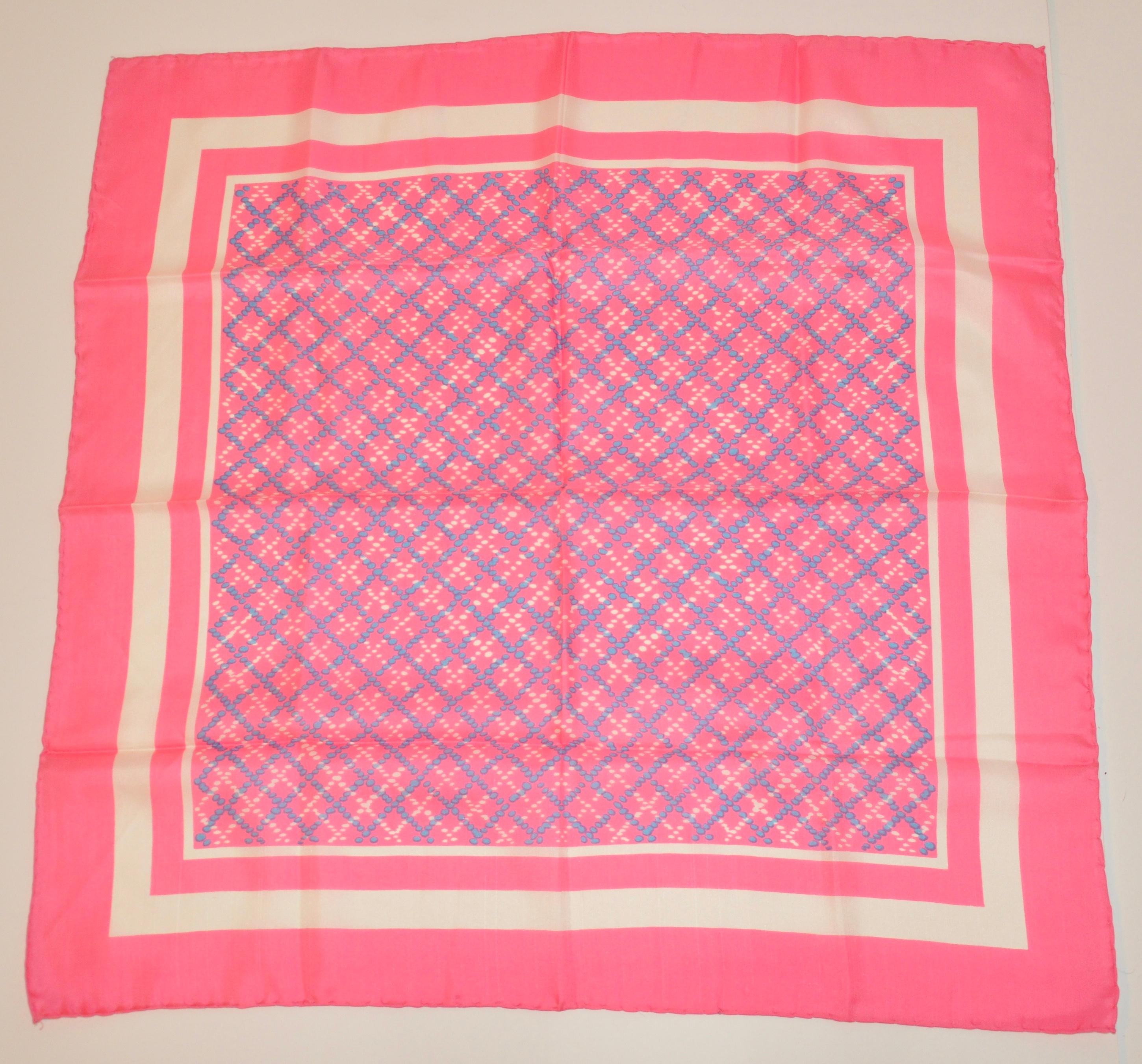      This wonderfully whimsical neon pink silk scarf accented with  specks of baby blue and white,  measures 30 inches by 30 inches. Edges are hand-rolled and Made in Italy.