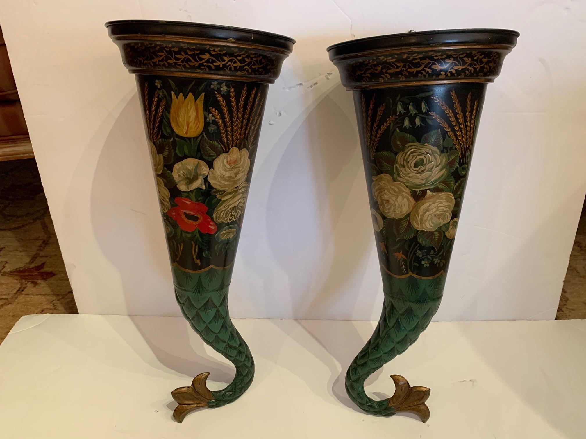 A delightful horn shaped pair of decorative tole wall pockets having black background and hand painted floral design.