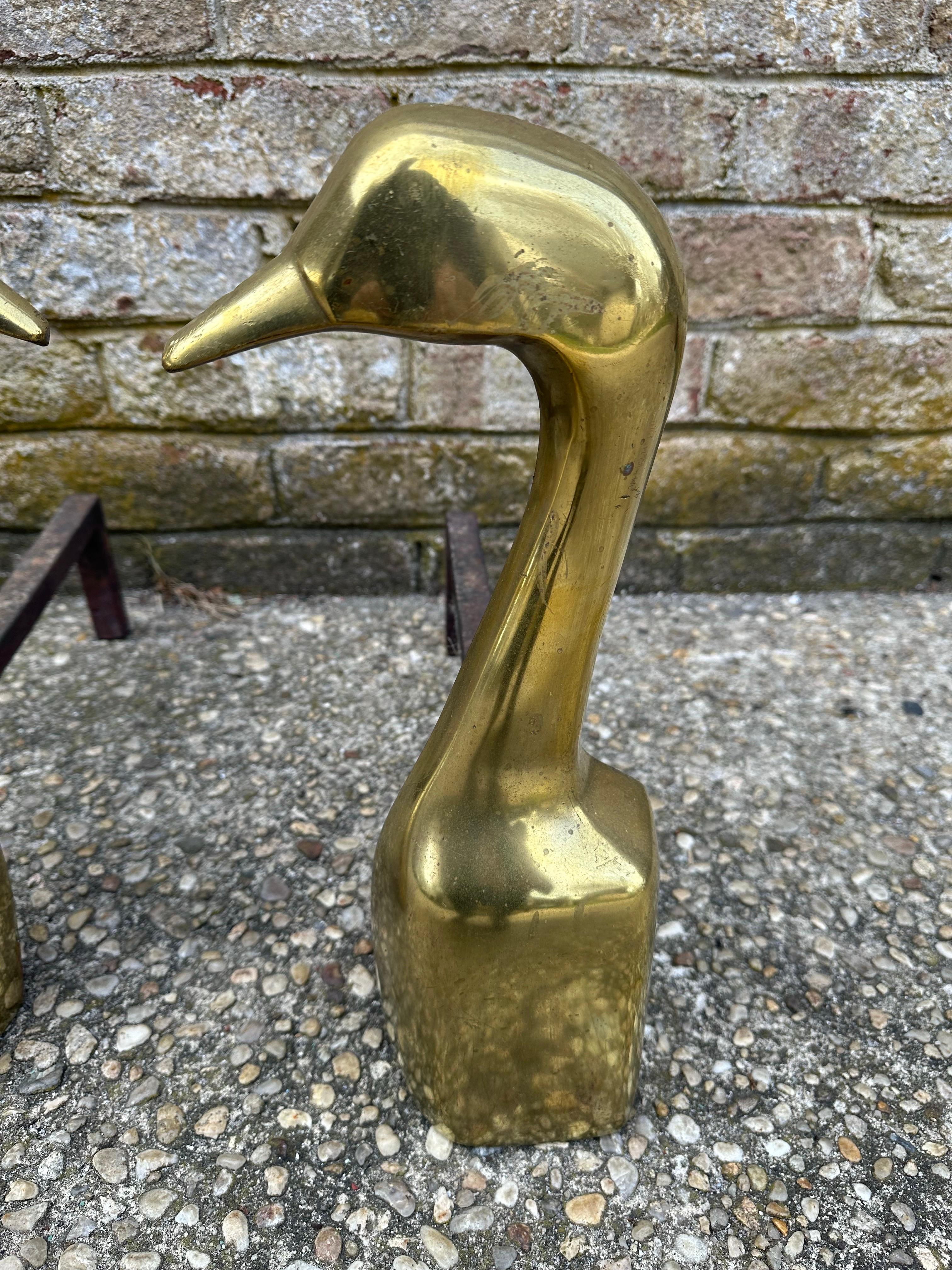 Solid brass pair of goose andirons.... cast iron support dogs.... 