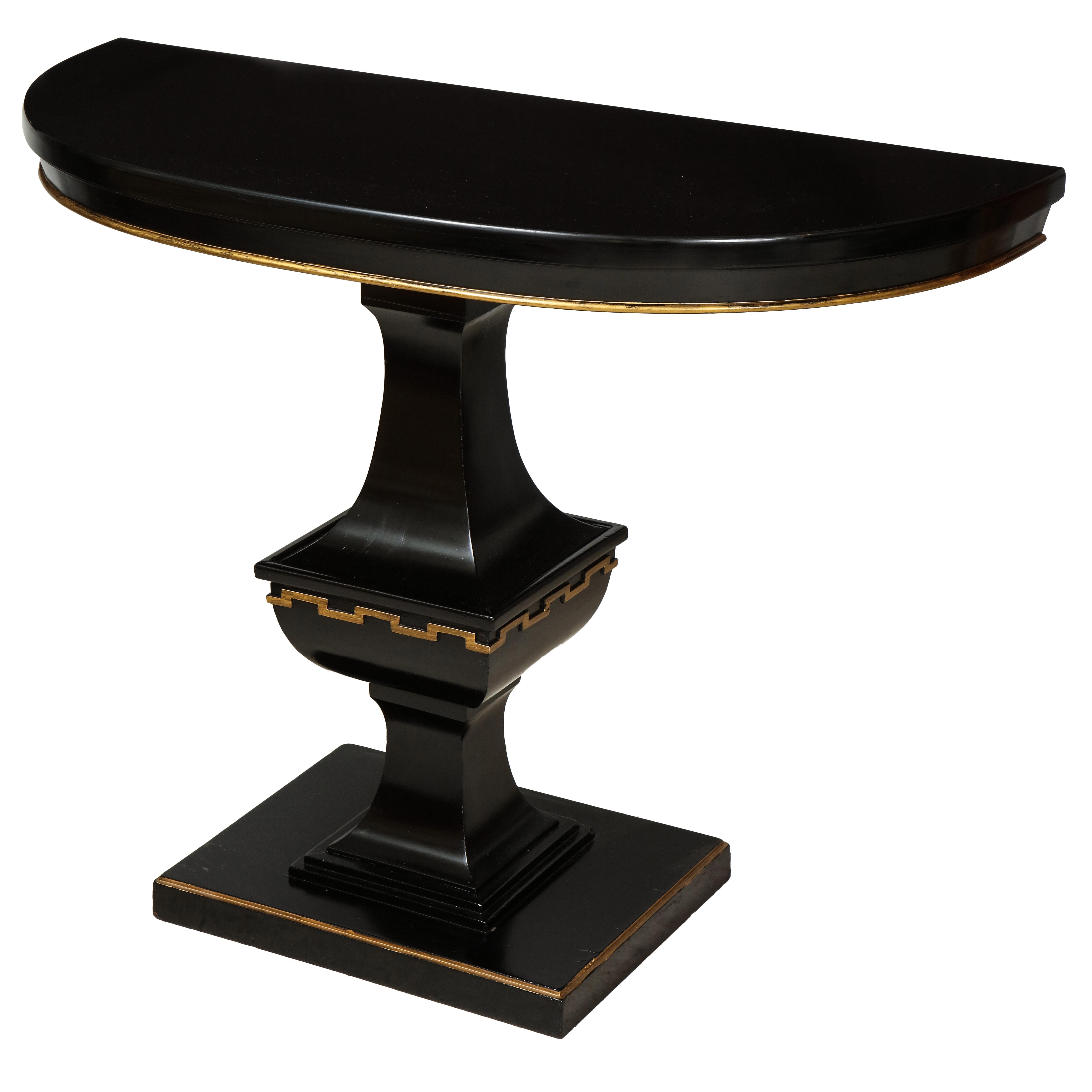 Whimsical pair of ebonized Hollywood Regency consoles, can be sold individually.