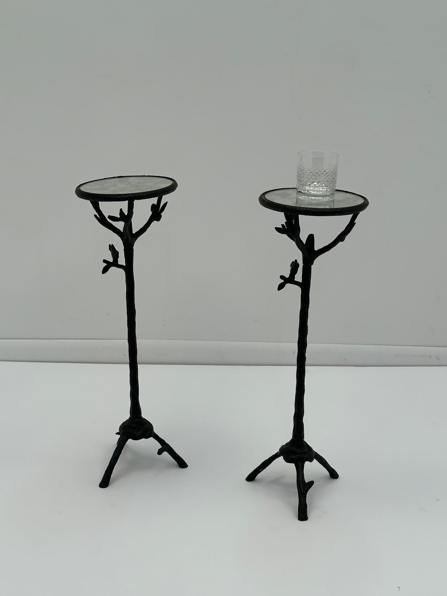 Whimsical pair of round iron sculpted martini tables having the look of twiggy branches and a couple of perched birds. The round glass tops are mirrored.