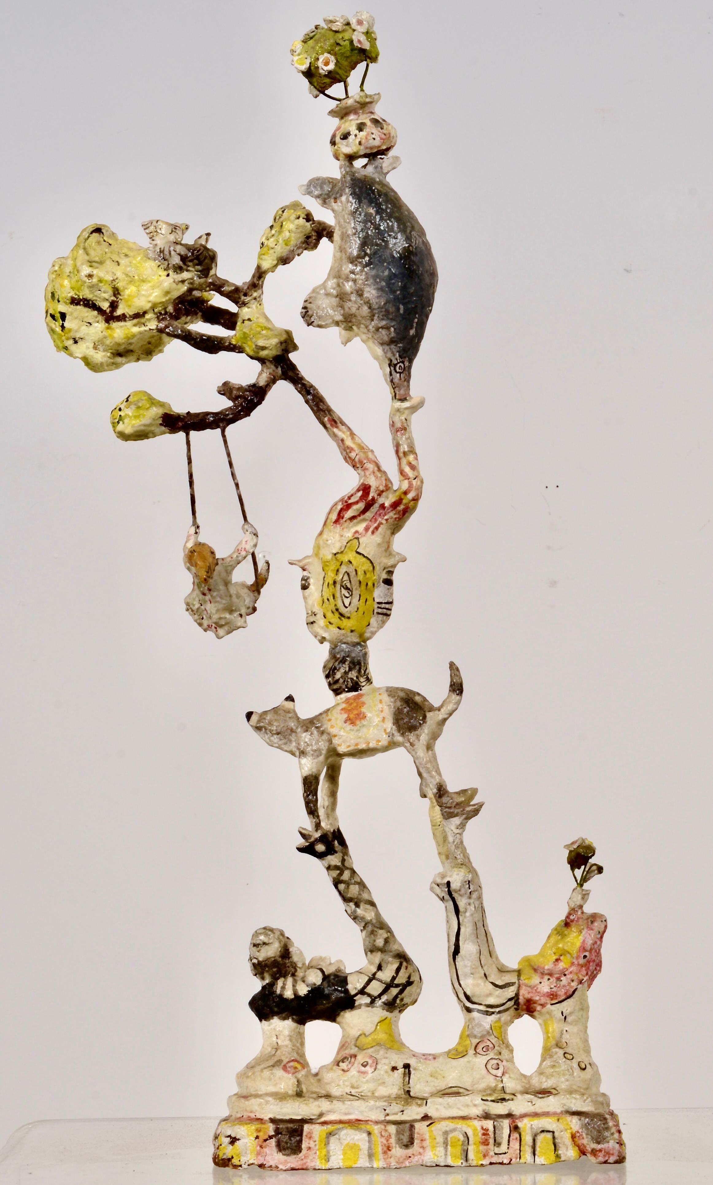 Completely charming paper mache  sculpture featuring whimsical circus performers forming a human (and animal) pyramid. Note the details such as baby birds in nest teetering on the top, the upside-down head on the support clown, the girl on the
