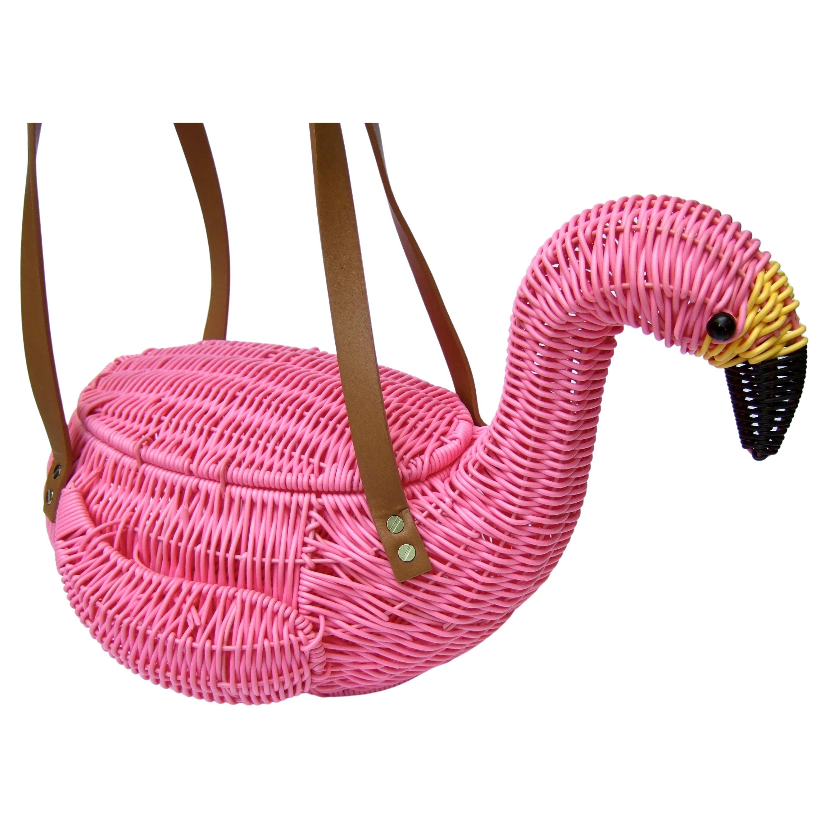 Whimsical pink wicker flamingo large basket style handbag c 21st c 
The unique pink wicker large size flamingo handbag is carried
with a pair of brown rubber handle straps 

Makes a fun quirky large -scale handbag; it too makes a charming
decorative