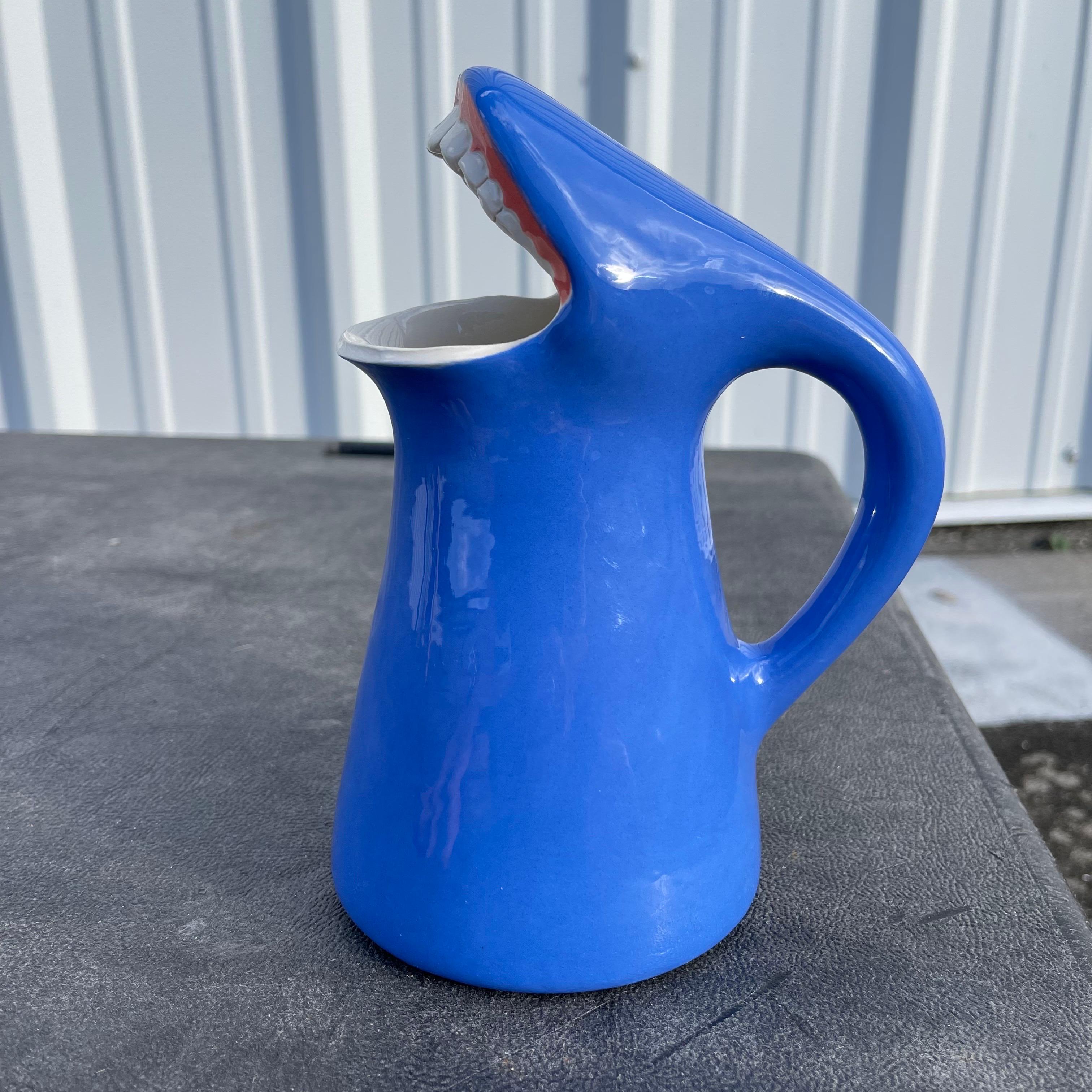 Whimsical pitcher in the form of an open mouth with teeth.