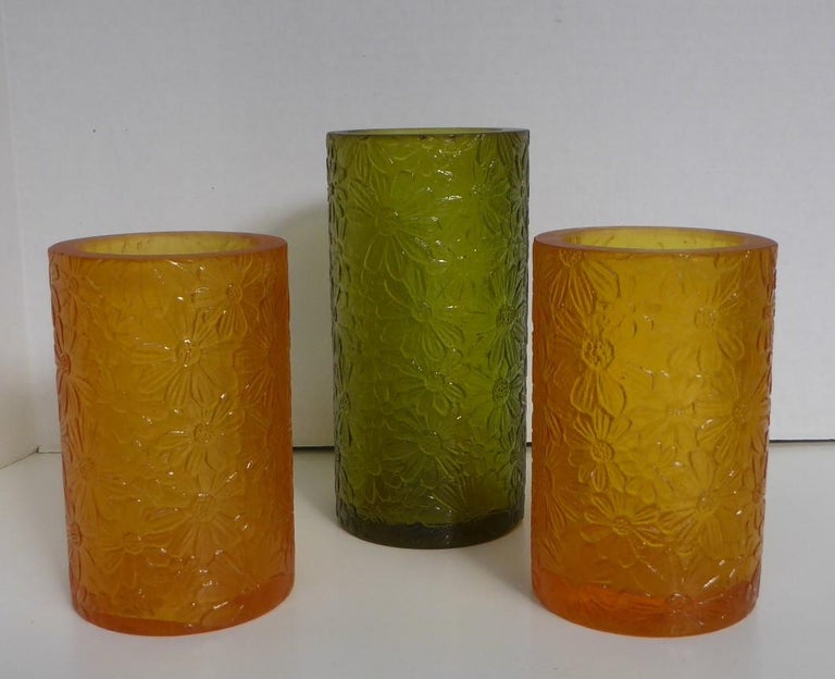 REDUCED FROM $350...Rarely seen form from the 1960s, a group of three Sascha B. Resin candleholders or vases with an overall impressed daisy design on a tubular shape. For votive / tea candles or as vases. Each etch signed Sascha B on the