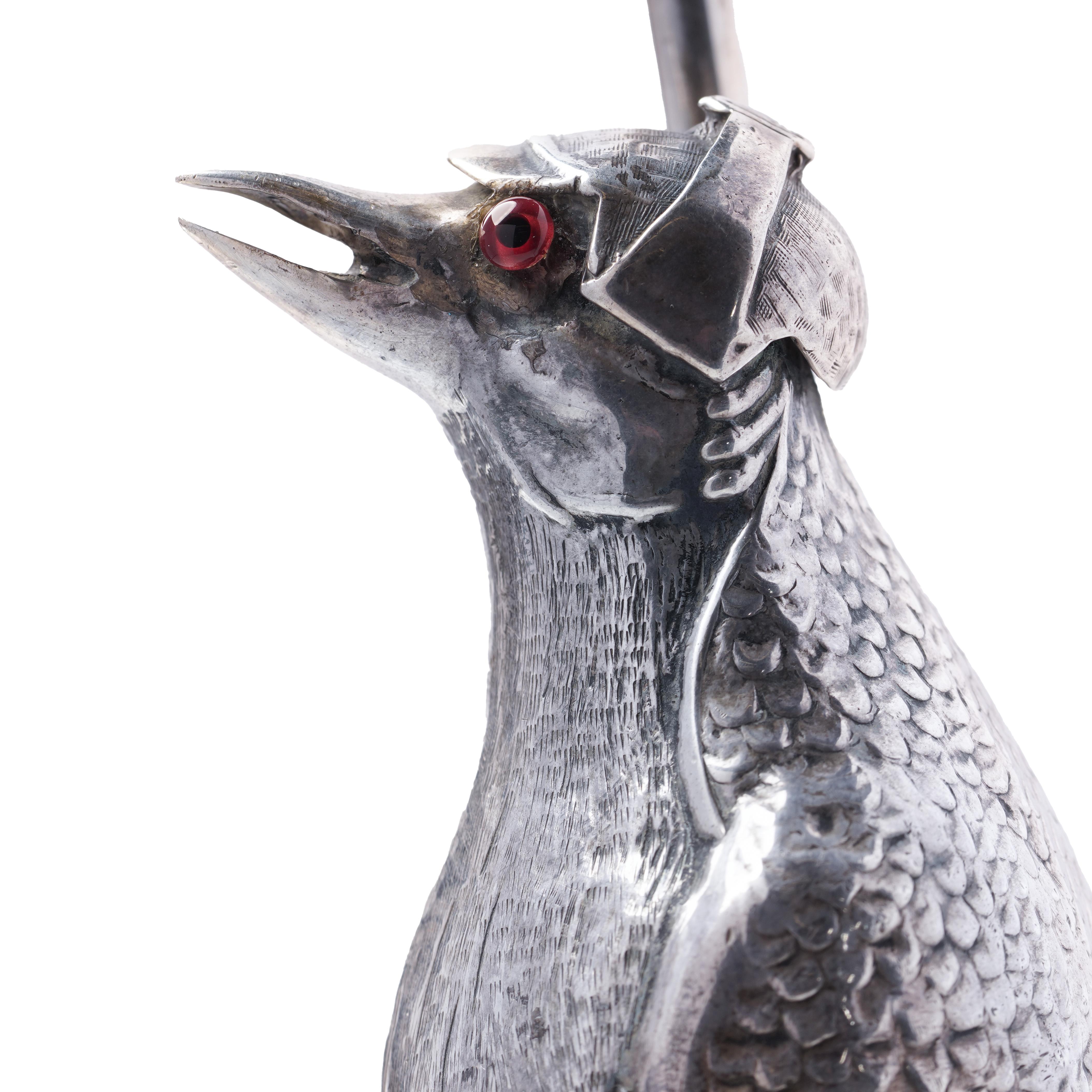 A whimsical and highly detailed Spanish novelty silver penguin, stamped to the underside of its webbed feet. The figure is charmingly modelled standing upright and dressed in shooting attire, complete with a hunter’s cap and a long rifle slung