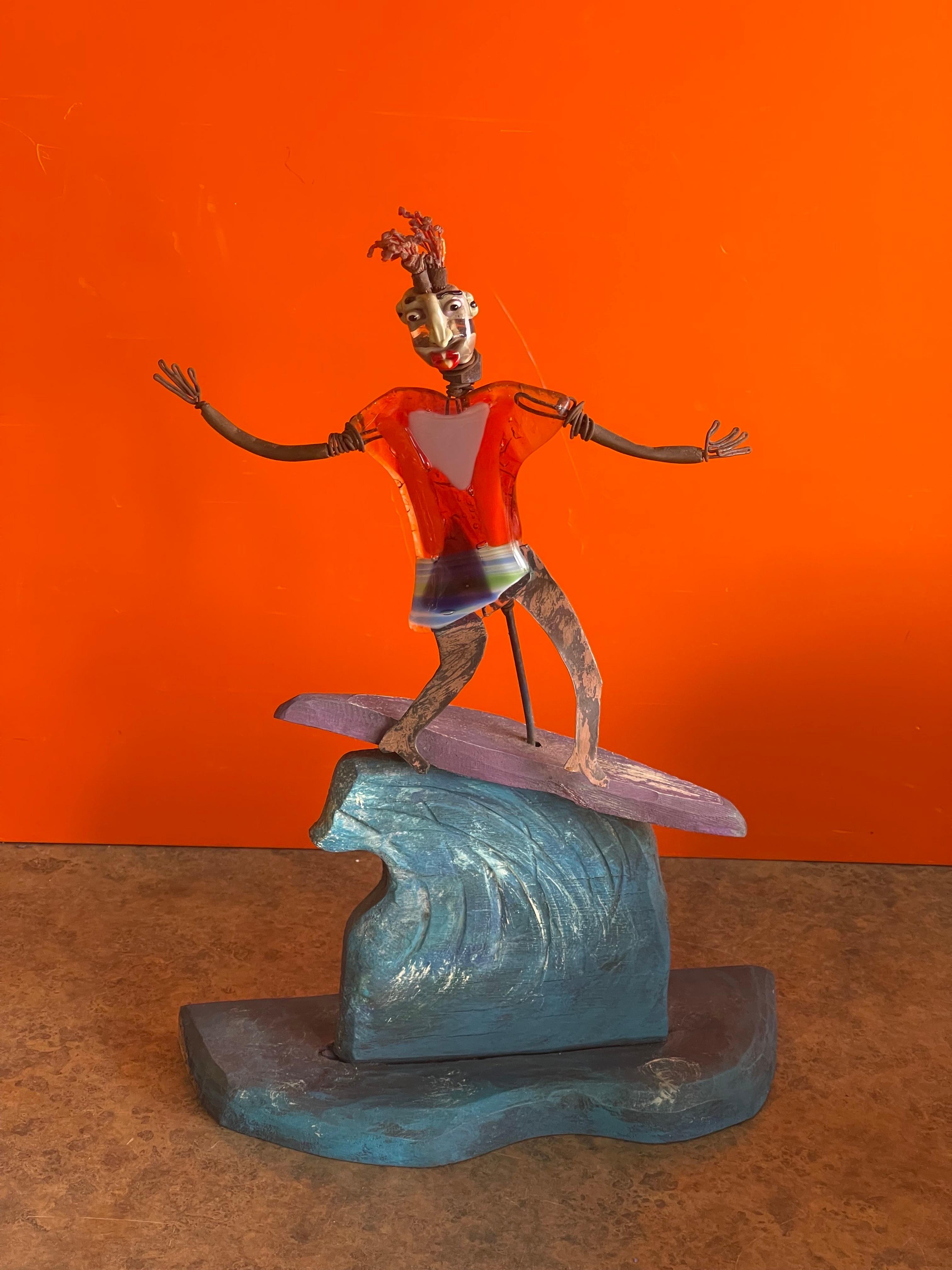 A really cool and whimsical surfer sculpture by Mitch Berg, circa 2008. The piece is in good vintage condition and measures 10.5