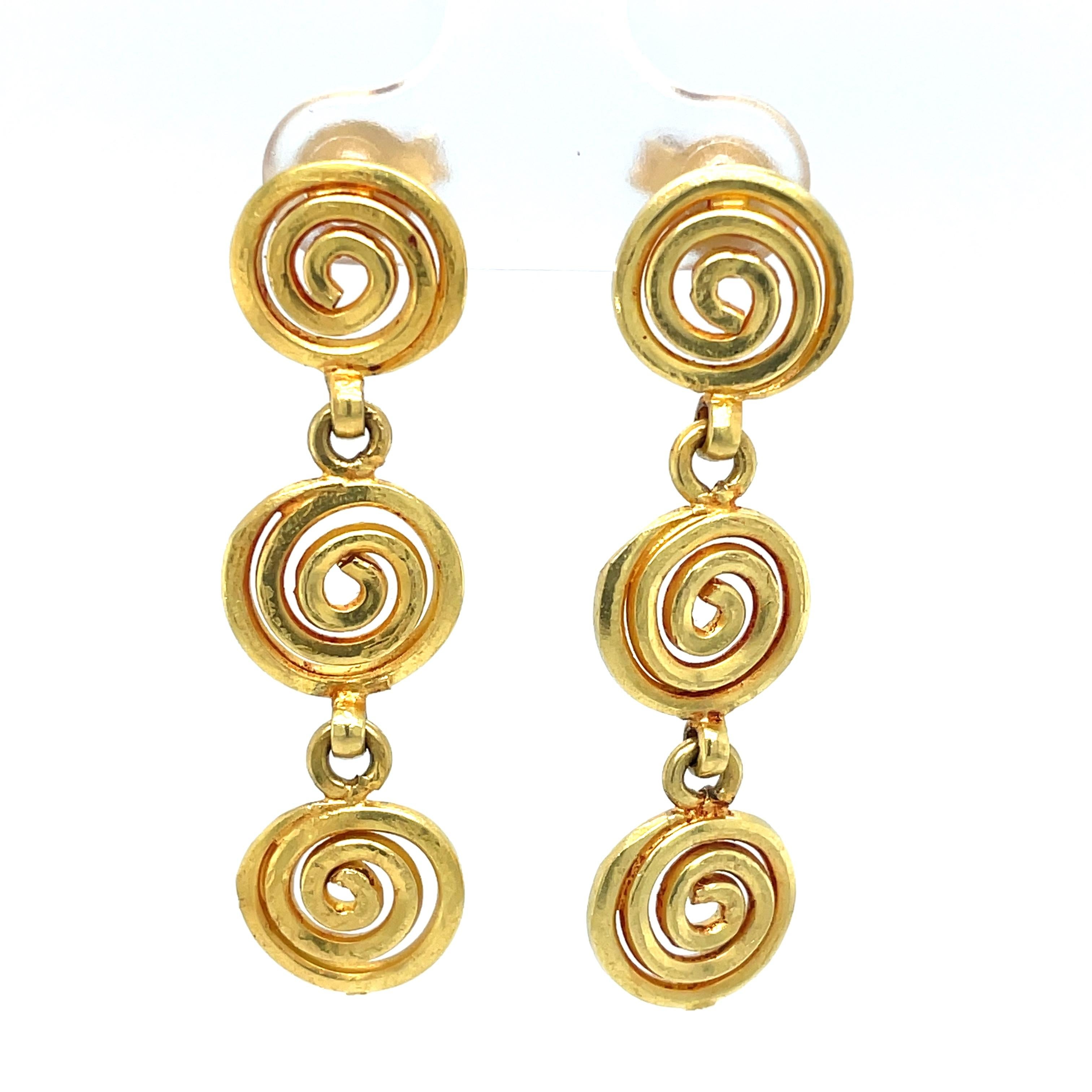 Three tiers of whimsical circular swirls in satin 18 karat yellow gold create this cheerful and colorful earring pair.  Artisan created, the width of the geo inspired swirls is 3/8 inch and the earring length is a pleasing 1-1/2 inches as it dangles
