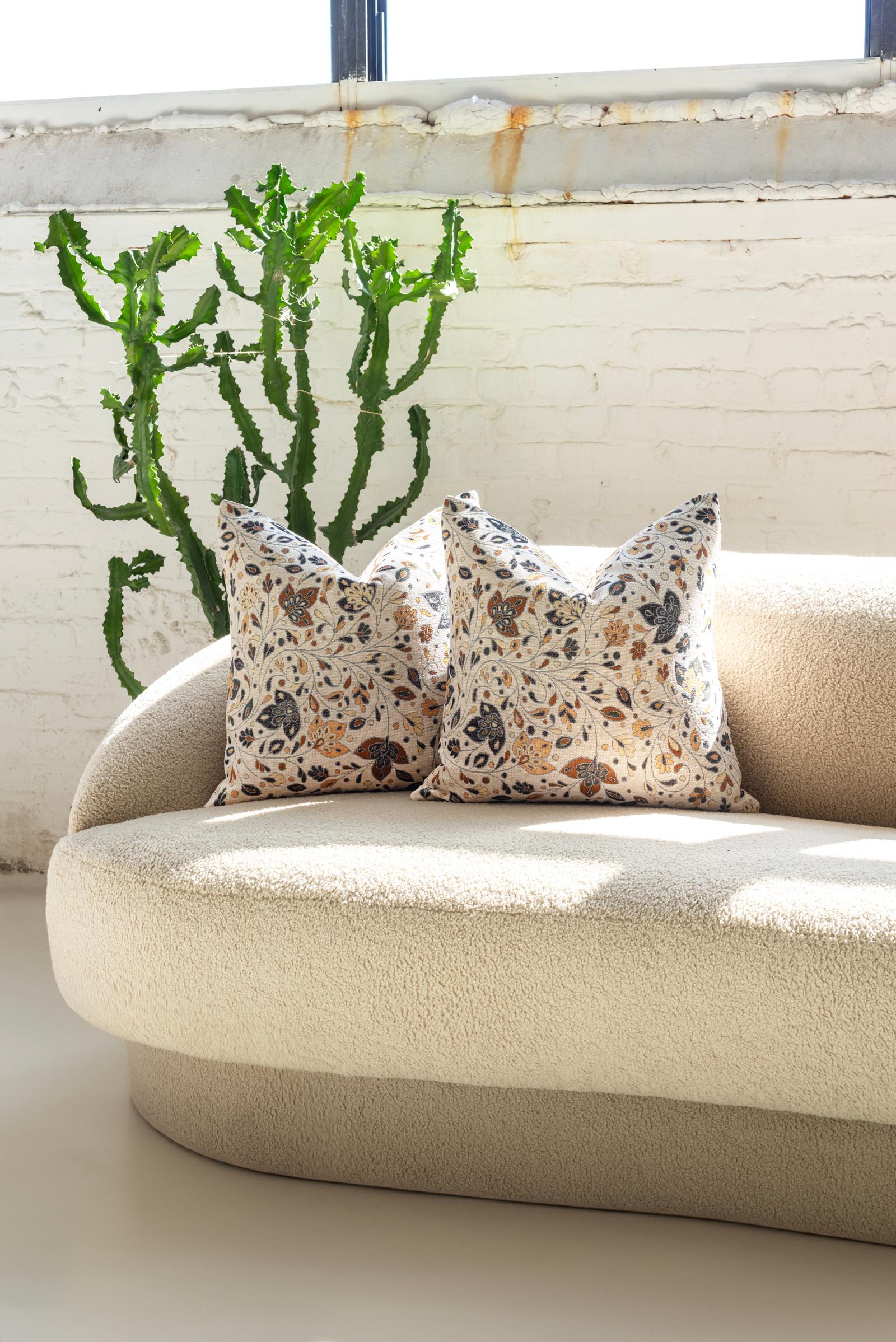 These luxurious down throw pillows, handcrafted with care in Chicago, feature a unique tapestry-like fabric that radiates comfort and style. The white background of the fabric serves as a serene canvas, beautifully contrasting with a whimsical,
