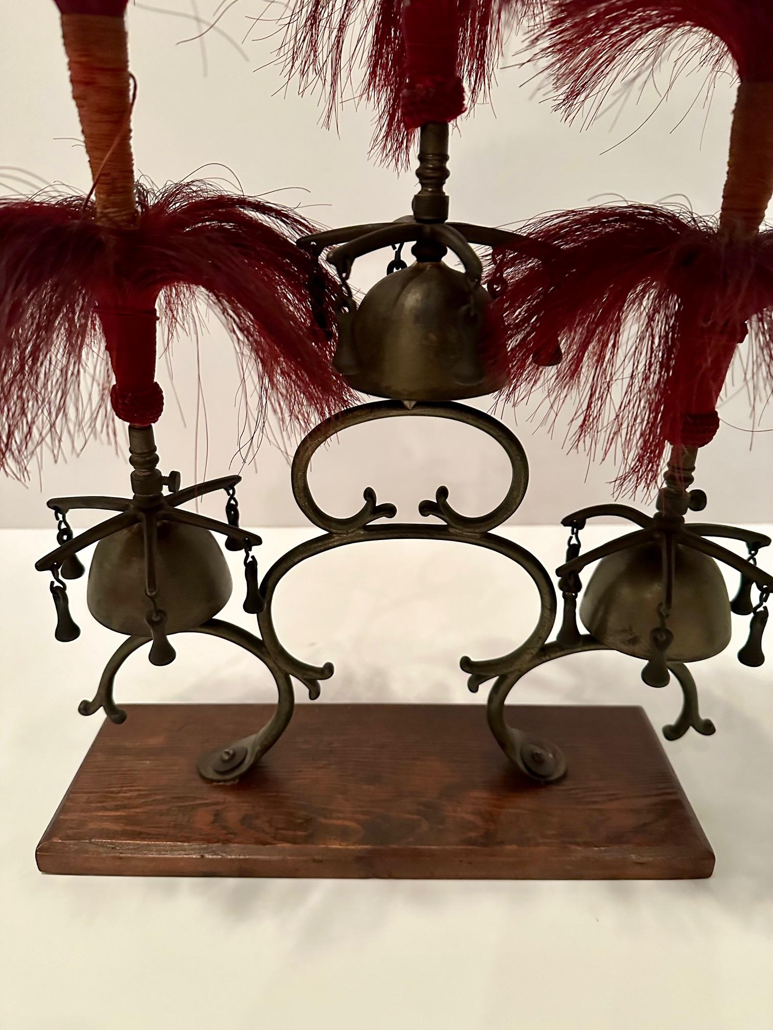 Whimsical antique brass and iron sleigh bells having marvelous maroon horse hair decoration and mounted on wooden base.
Base 12.5 x 4.5