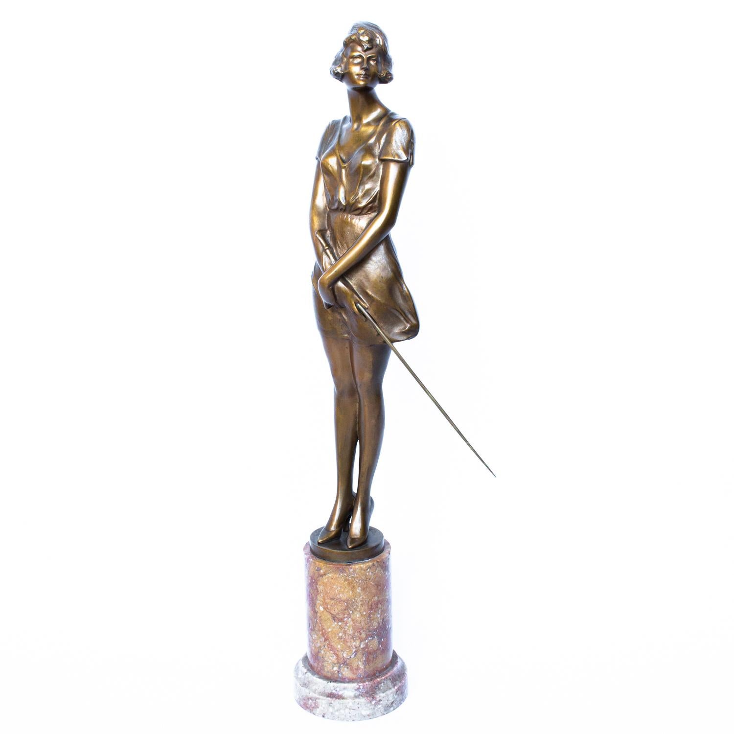 An Art Deco, gilt bronze figure of a beautiful woman, poised holding a riding whip. Signed 
