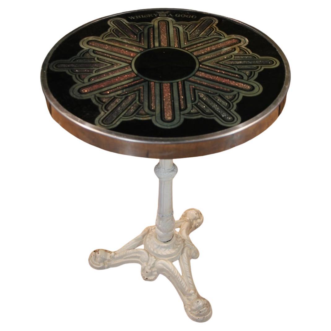 Pedestal table marked with the famous Parisian nightclub Le Whisky a Go Go. White lacquered cast iron base, stainless steel and glass top. In good condition, with scratches from use and wear. Le Whisky a Go Go opened on January 15, 1964. It owes its