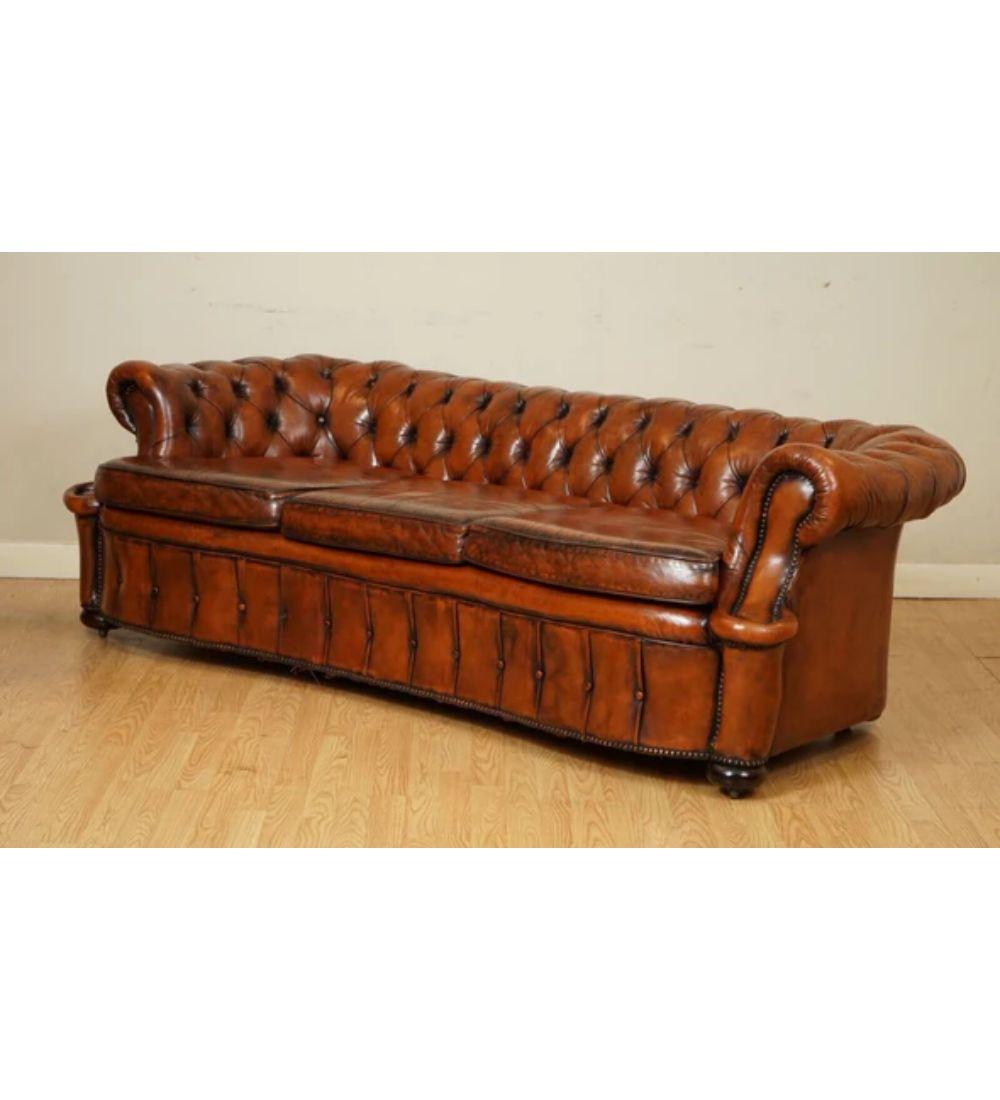 We are delighted to offer for sale this one of a kind restored hand-dyed whiskey brown serpentine club leather sofa.

This is a solid and very good quality sofa, our restorers have restored this by stripping the previous colour, and then after