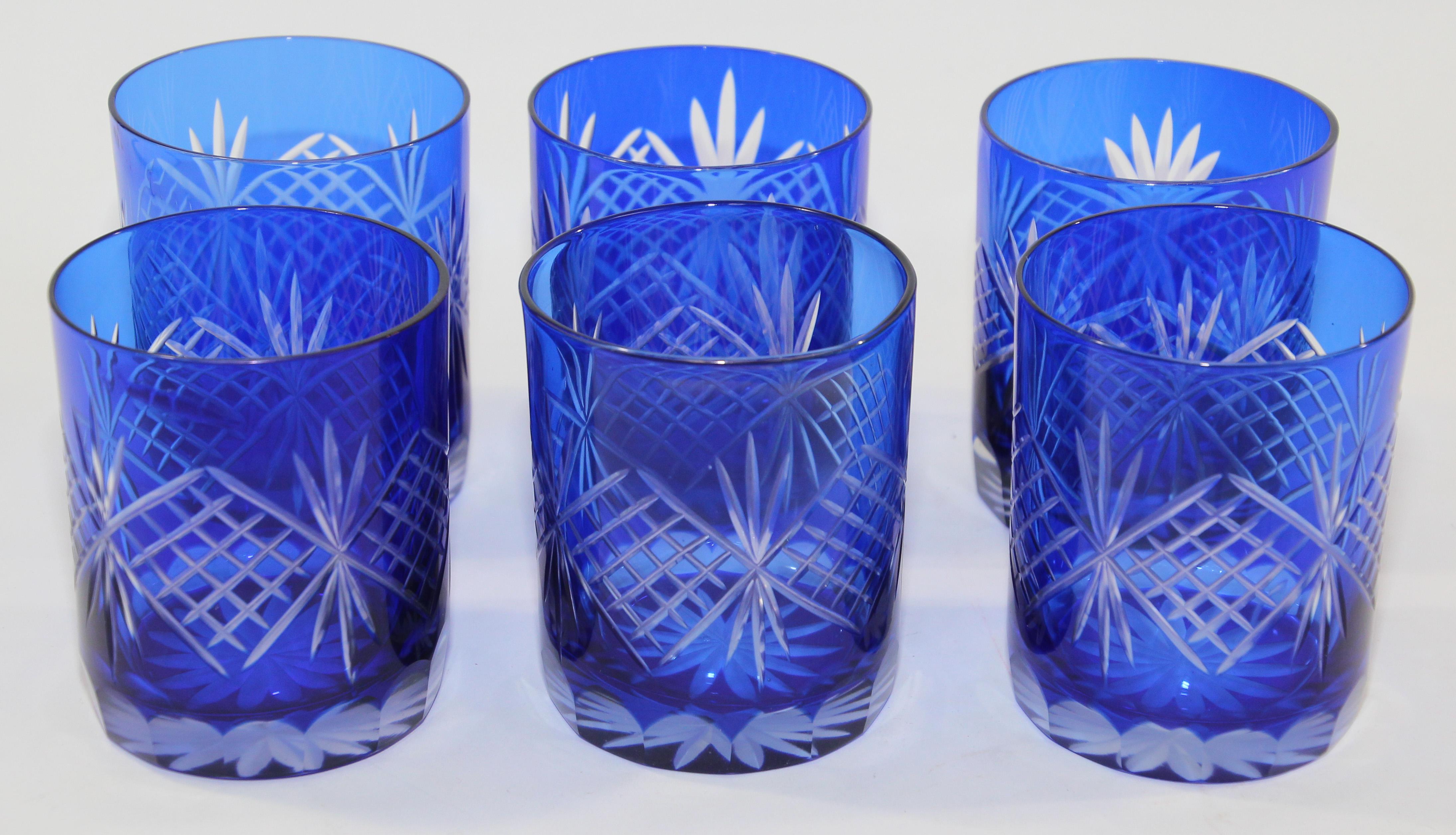 Set of six vintage whiskey glasses tumbler cobalt blue crystal Baccarat style. 
The vibrant hand blown rich sapphire blue jewel sapphire blue crystal glass is cut to clear to reveal a lovely pattern with clean lines. 
Set of rock whiskey juice or