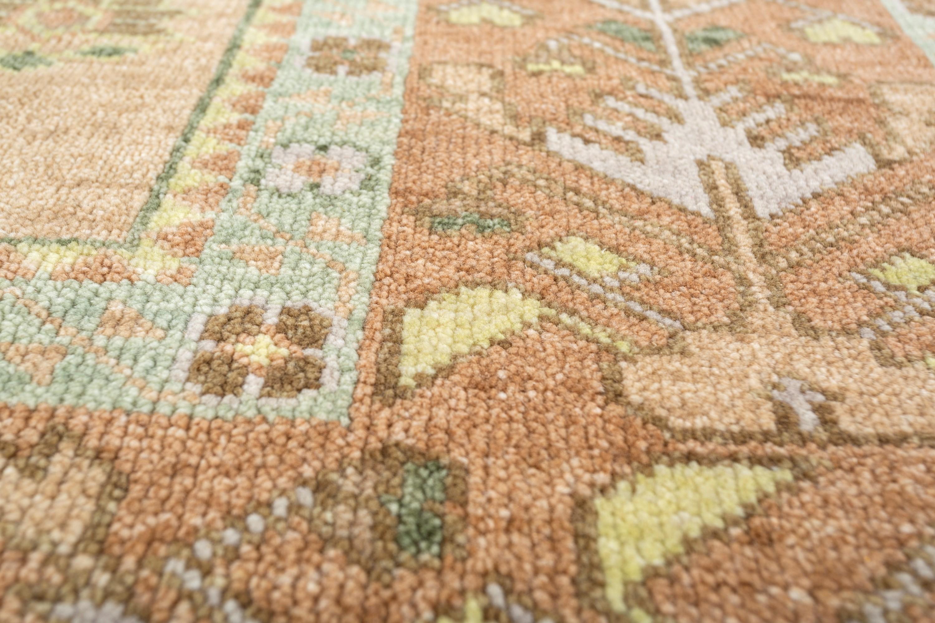 A bridge between worlds, where tradition meets modernity - this hand-knotted rug embodies this very essence, seamlessly blending the rich heritage of tribal motifs with a modern color scheme. The rug's light peach ground color acts as a blank
