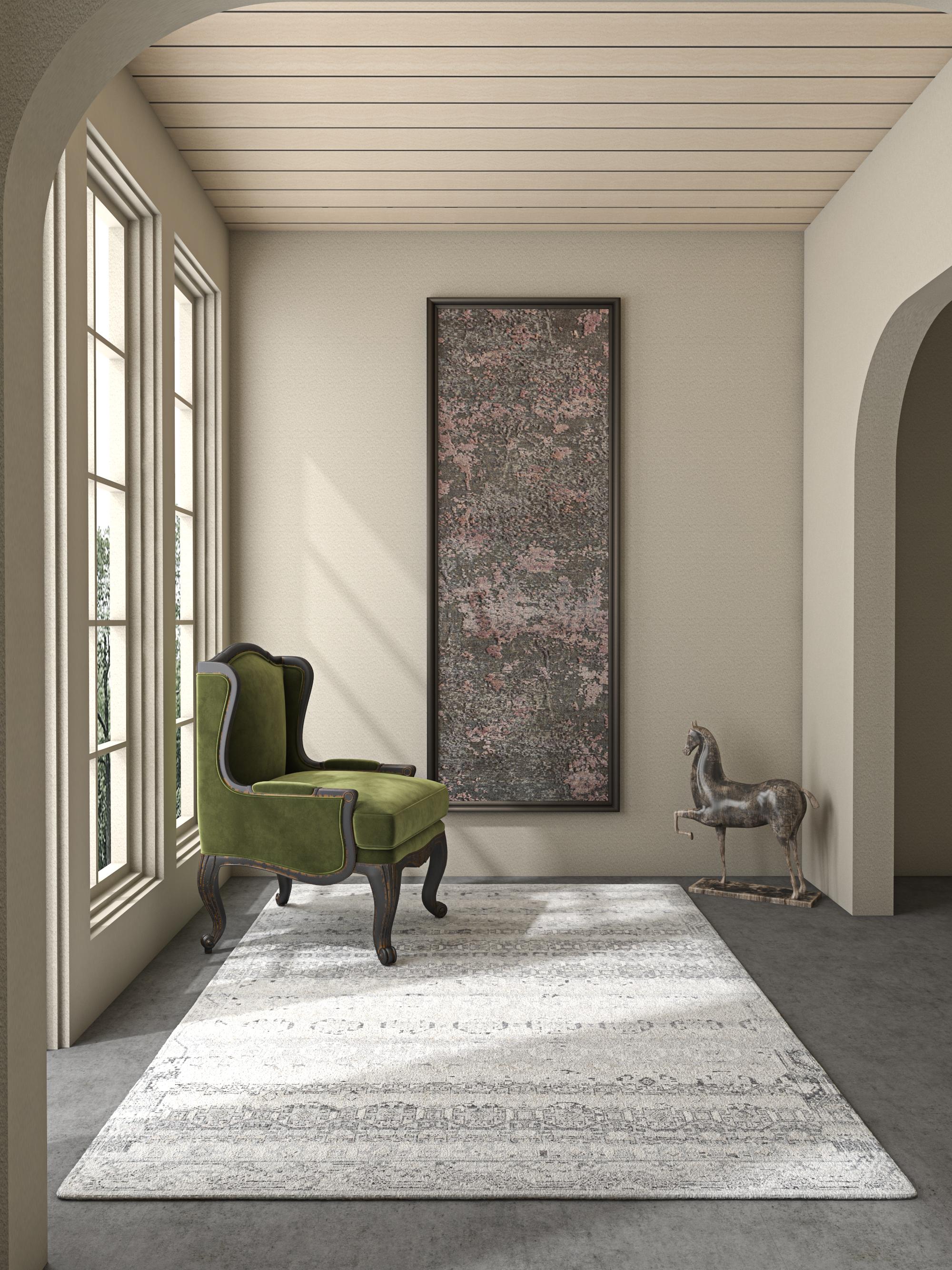 Elevate your space with this handknotted rug , a masterpiece in medium taupe wool with a crisp white border. Immerse yourself in the artistry, inspired by primitive cultures worldwide, meticulously hand-knotted to perfection. This heirloom piece