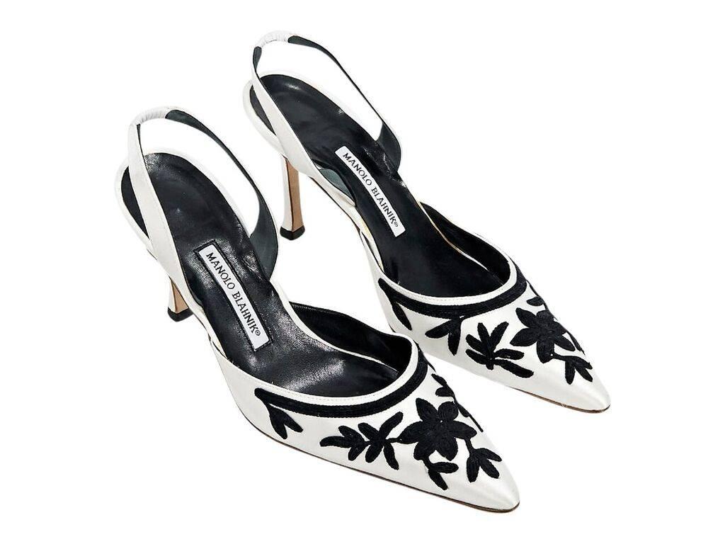 Product details:  White satin slingback pumps by Manolo Blahnik.  Accented with black embroidery.  Point toe.  Slip-on style. Label size EU 41.5.  4