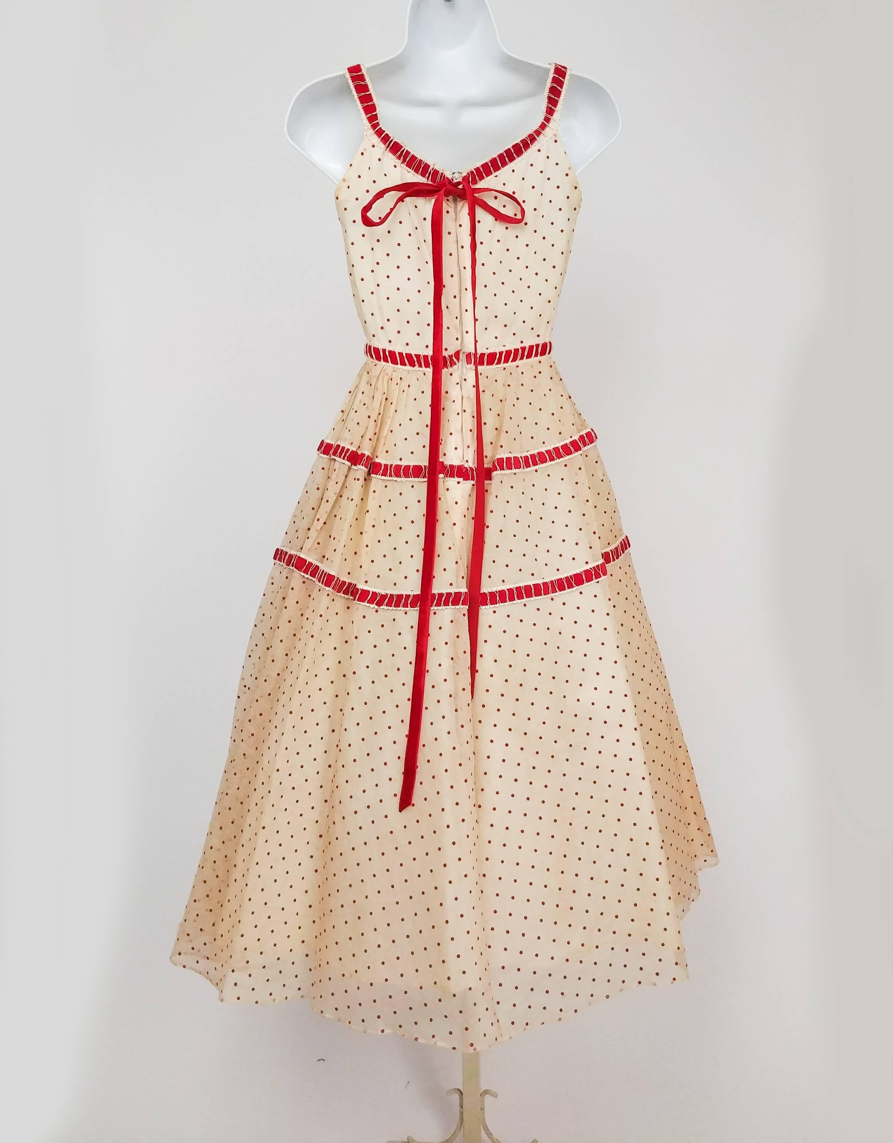White & Red Organza Polka Dot Party Dress, 1950s. Silk organza dress with red flocked velvet polka dots and velvet ribbon trim, including adorable velvet ribbon bow at back over the metal zipper closure. In a petite size. Dress is photographed over