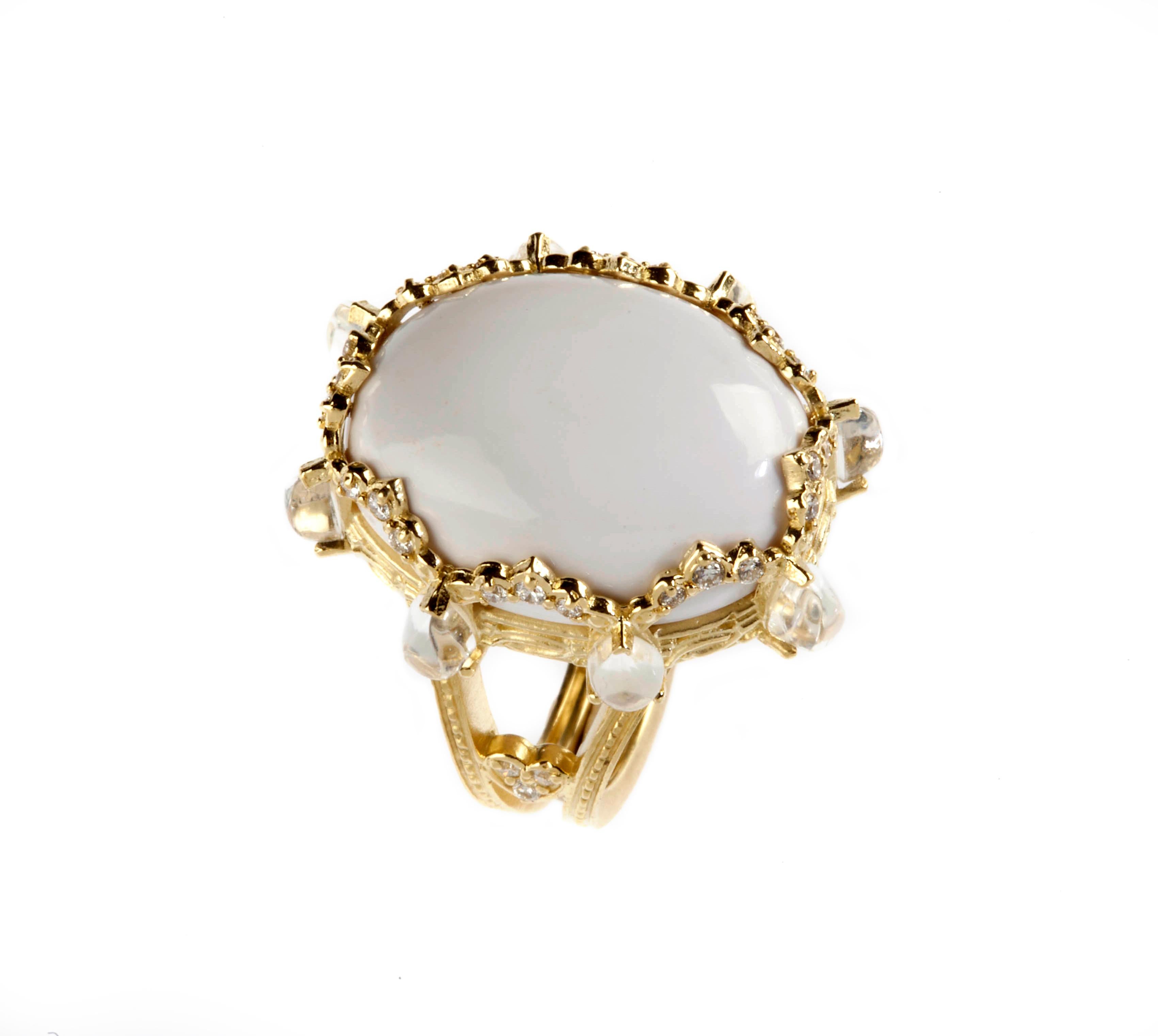 18K Gold and Diamond Oval Ring with White Agate Center and Rainbow Moonstones by Stambolian

Center stone is a 18.00 carat White Agate Center, 20 x 15mm

Surrounding the Center Stone are 0.22 carat G color VS clarity diamonds and eight Pear shape