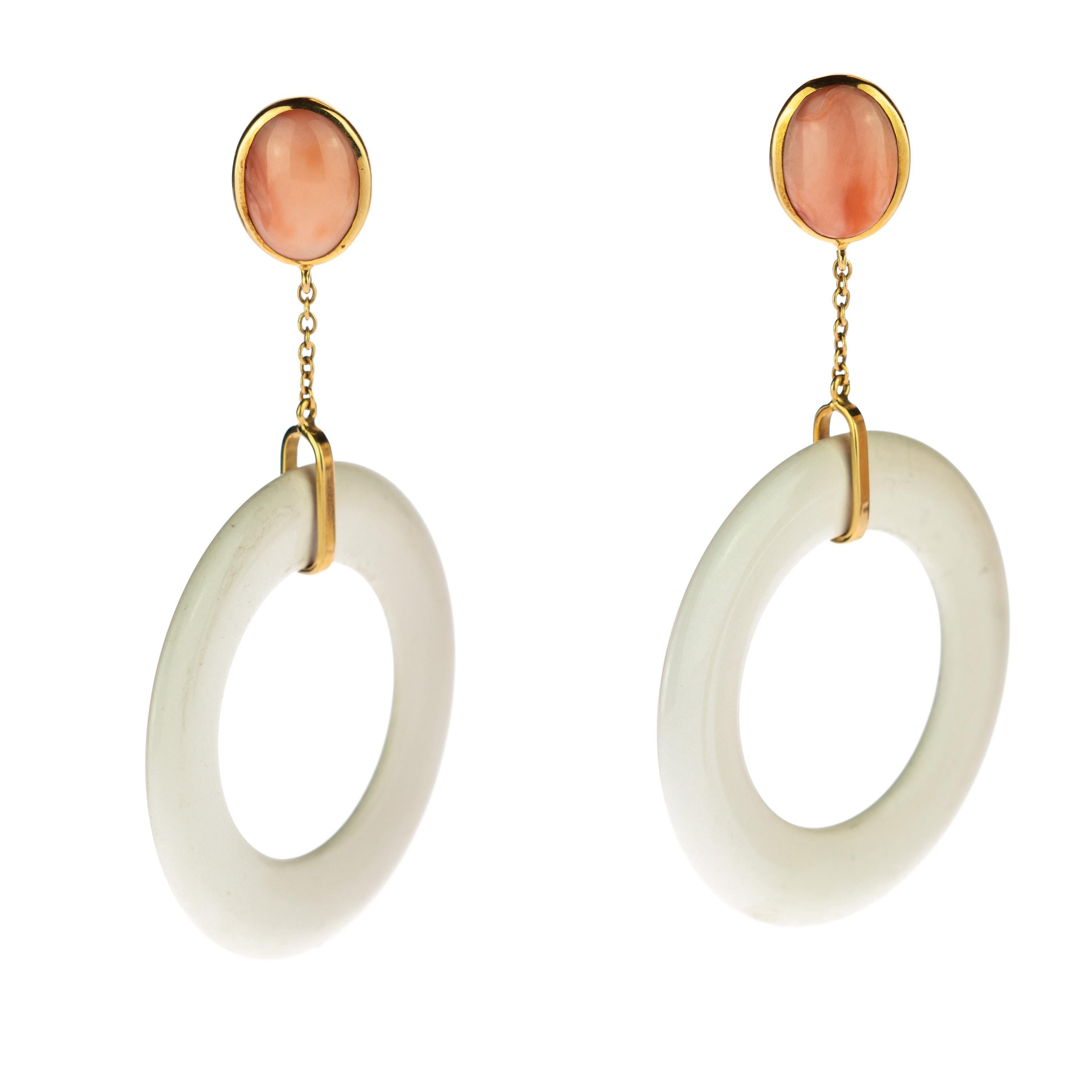 Unique and modern piece designed with a classy and elegant style. Pink coral earrings, surrounded by delicate 18k yellow gold, emphasizing its figure. Followed by a gold chain which ends in a rectangle gold hook that holds a modern white agate