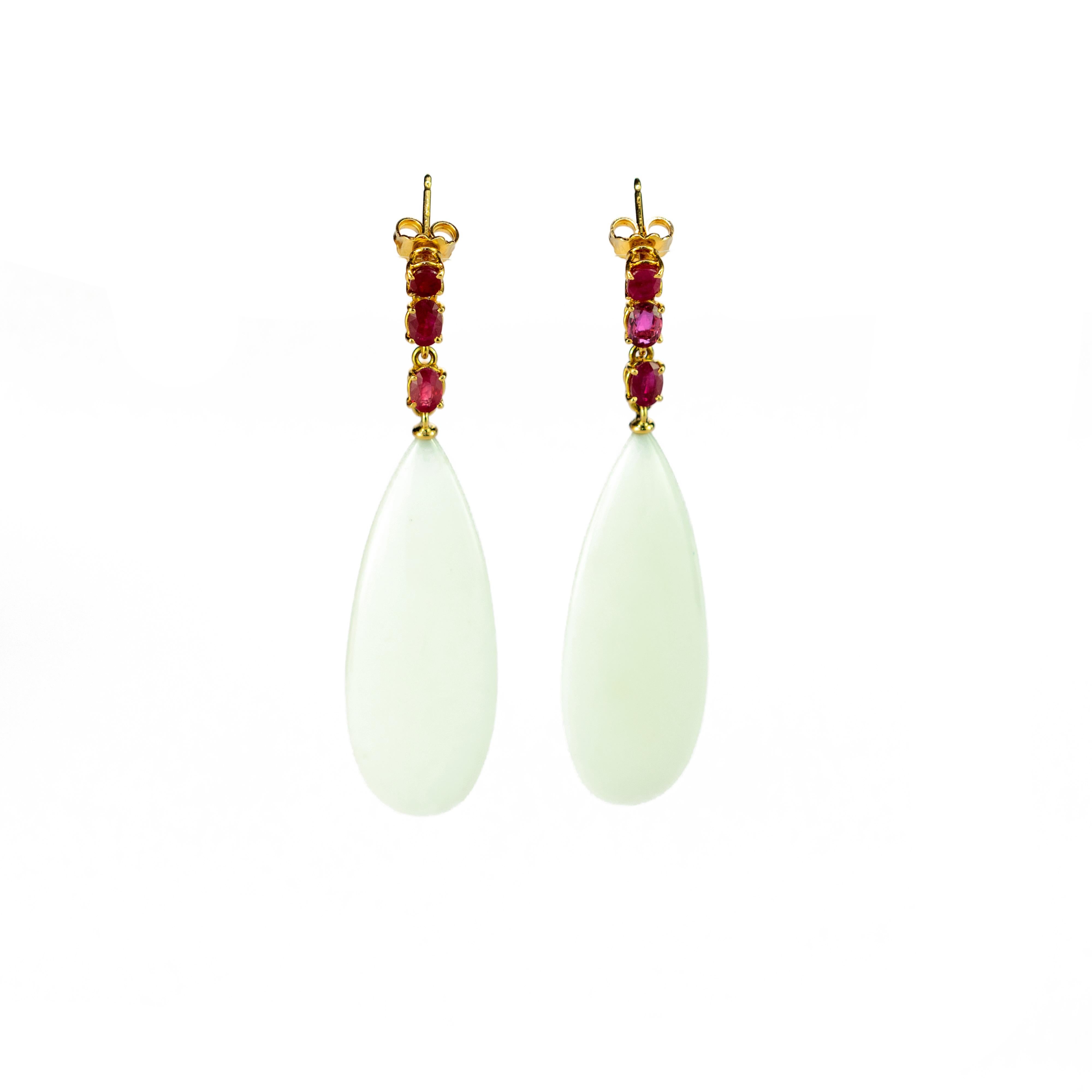 White agate chandelier long drops with six rubies gems combining voluminous shapes with vivid colours, resulting in bold, free-spirited pieces with a charming elegance.

This design is inspired by the magic of the Northern Lights. The white melts in
