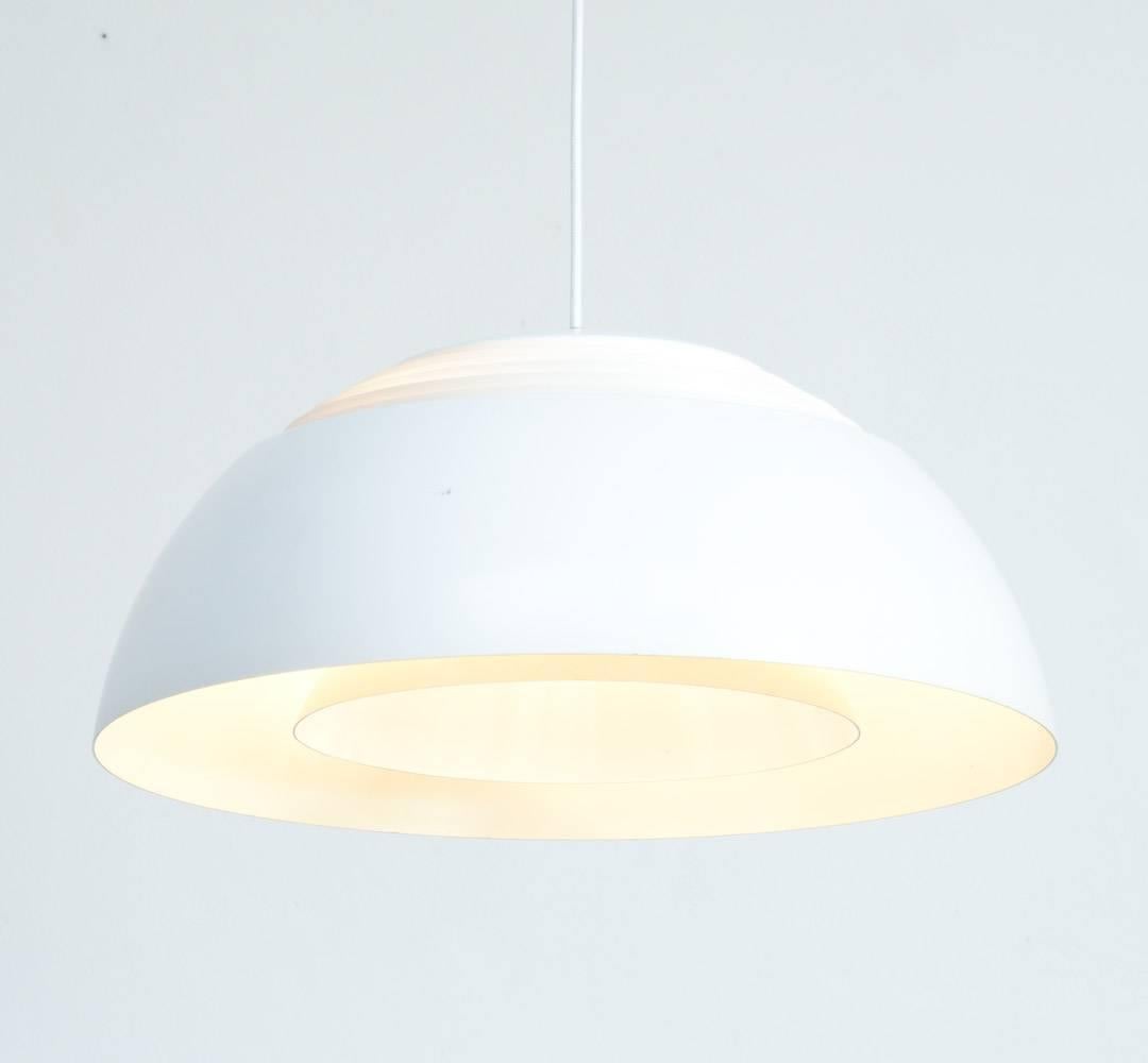 Arne Jacobsen designed the AJ Royal pendant lamp for the SAS Royal Hotel in Copenhagen in 1957. It was published by Louis Poulsen.
The metal shade is white lacquered. A white lacquered inner shade diffuses the light upwards and downwards, so this