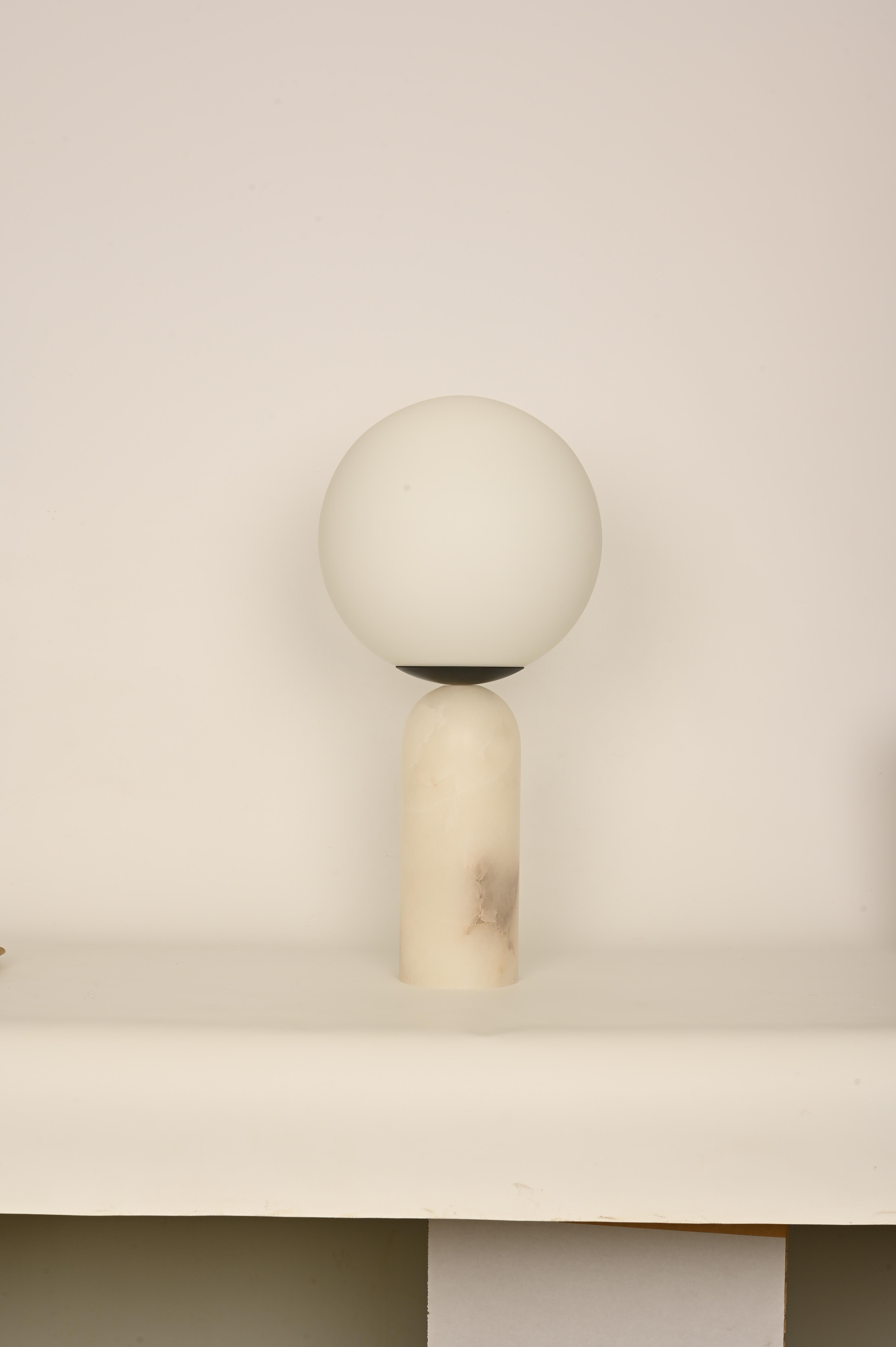 White Alabaster and Steel Atlas Table Lamp by Simone & Marcel
Dimensions: Ø 30 x H 60 cm.
Materials: Glass, blackened steel and white alabaster.

Also available in different marble, wood and alabaster options and finishes. Custom options available
